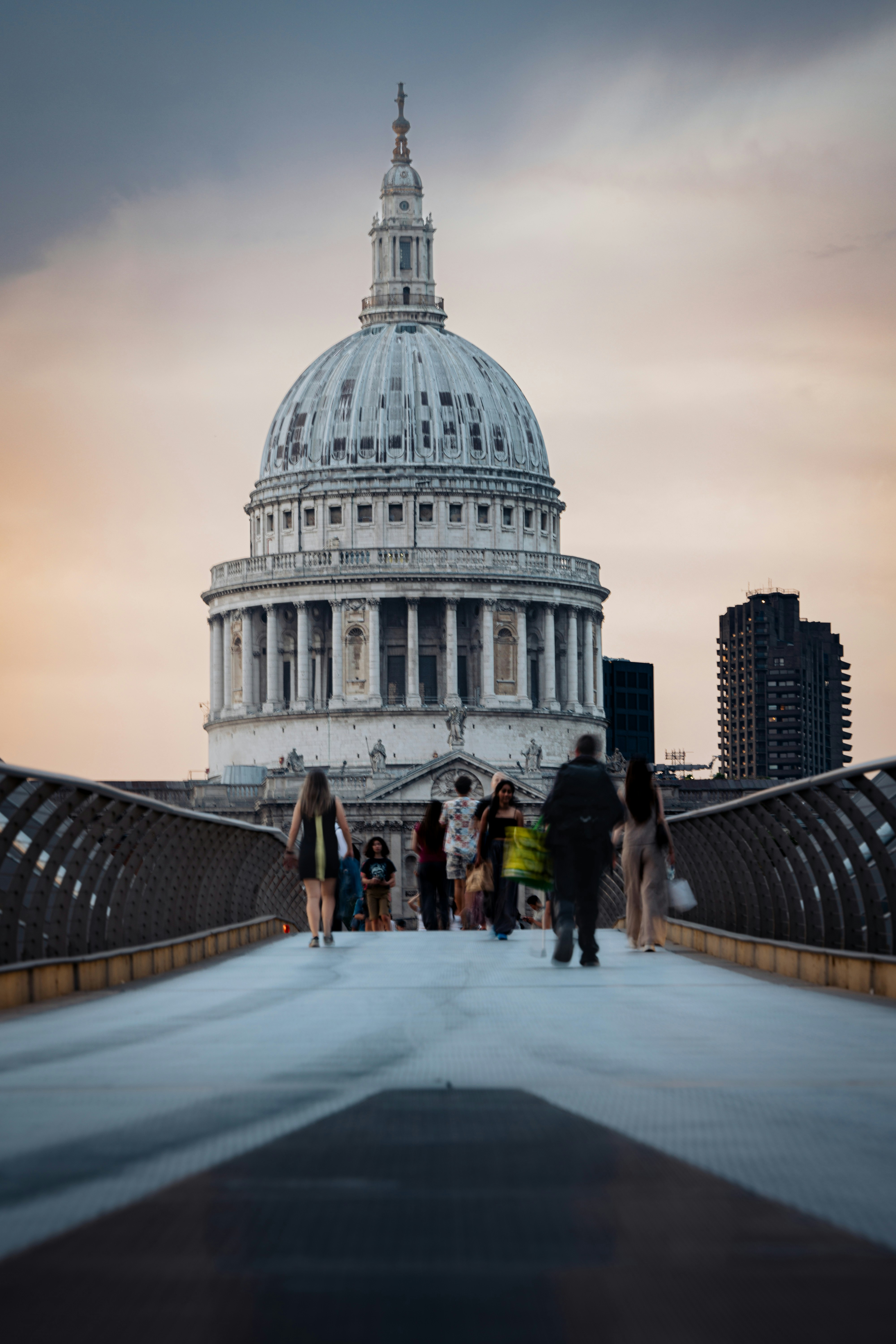 People walking on bridge towards st. paul's cathedral