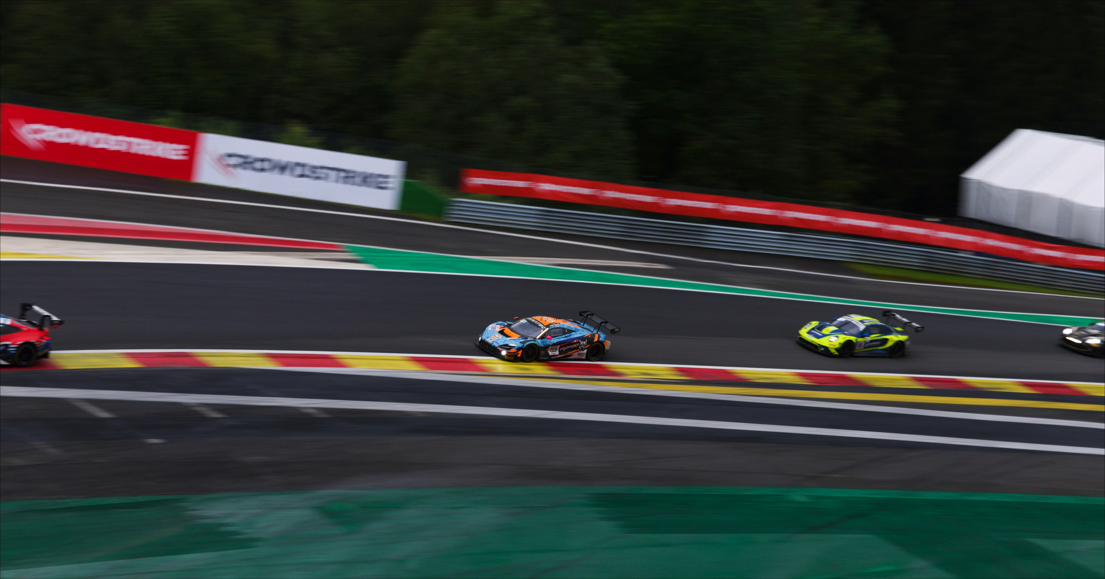 Race cars speeding around a track during a competition