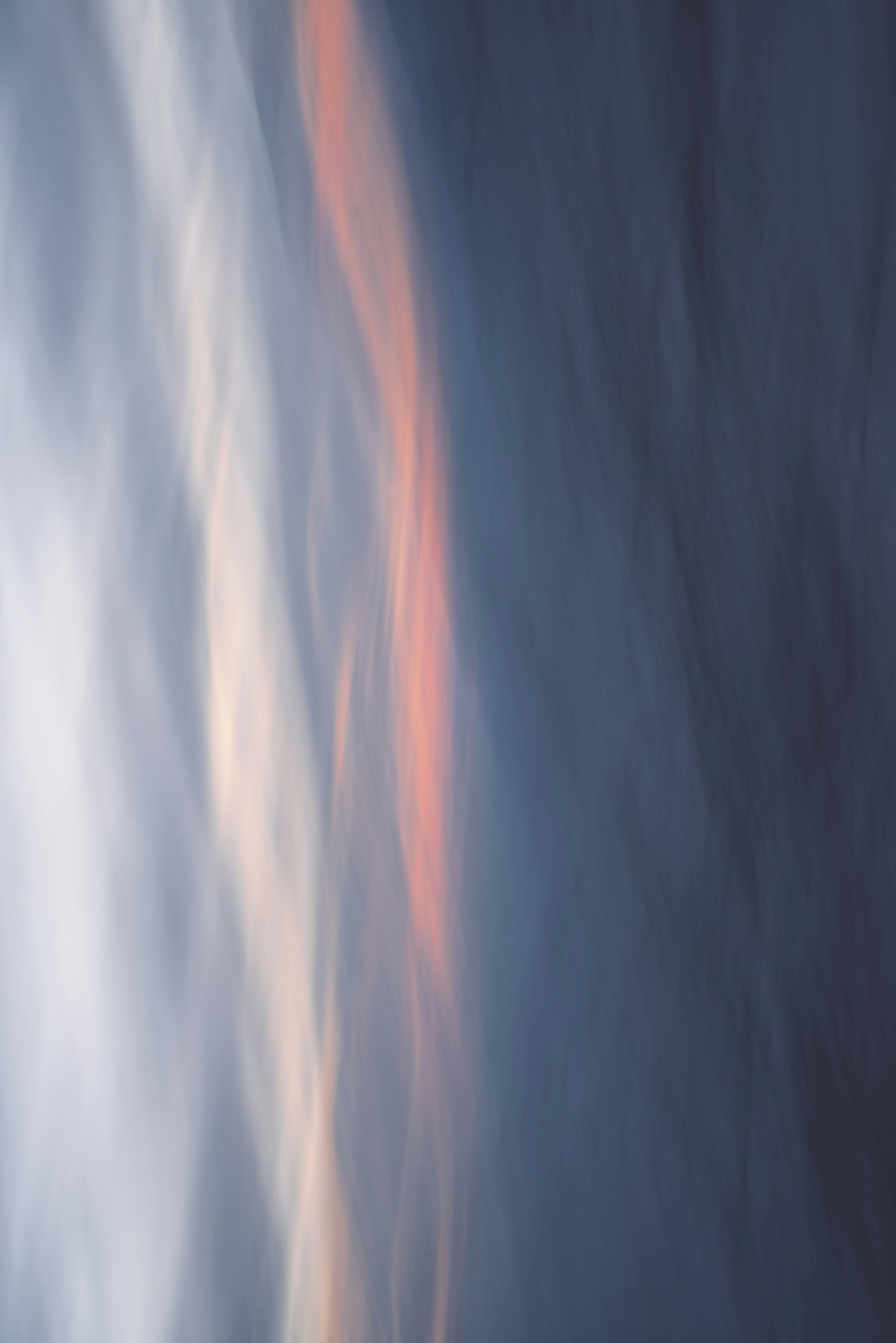 Abstract vertical streaks of blue, white, and orange.