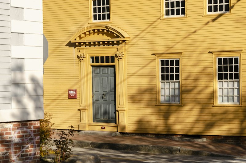 A traditional revival-style home with a balanced façade and formal entrance