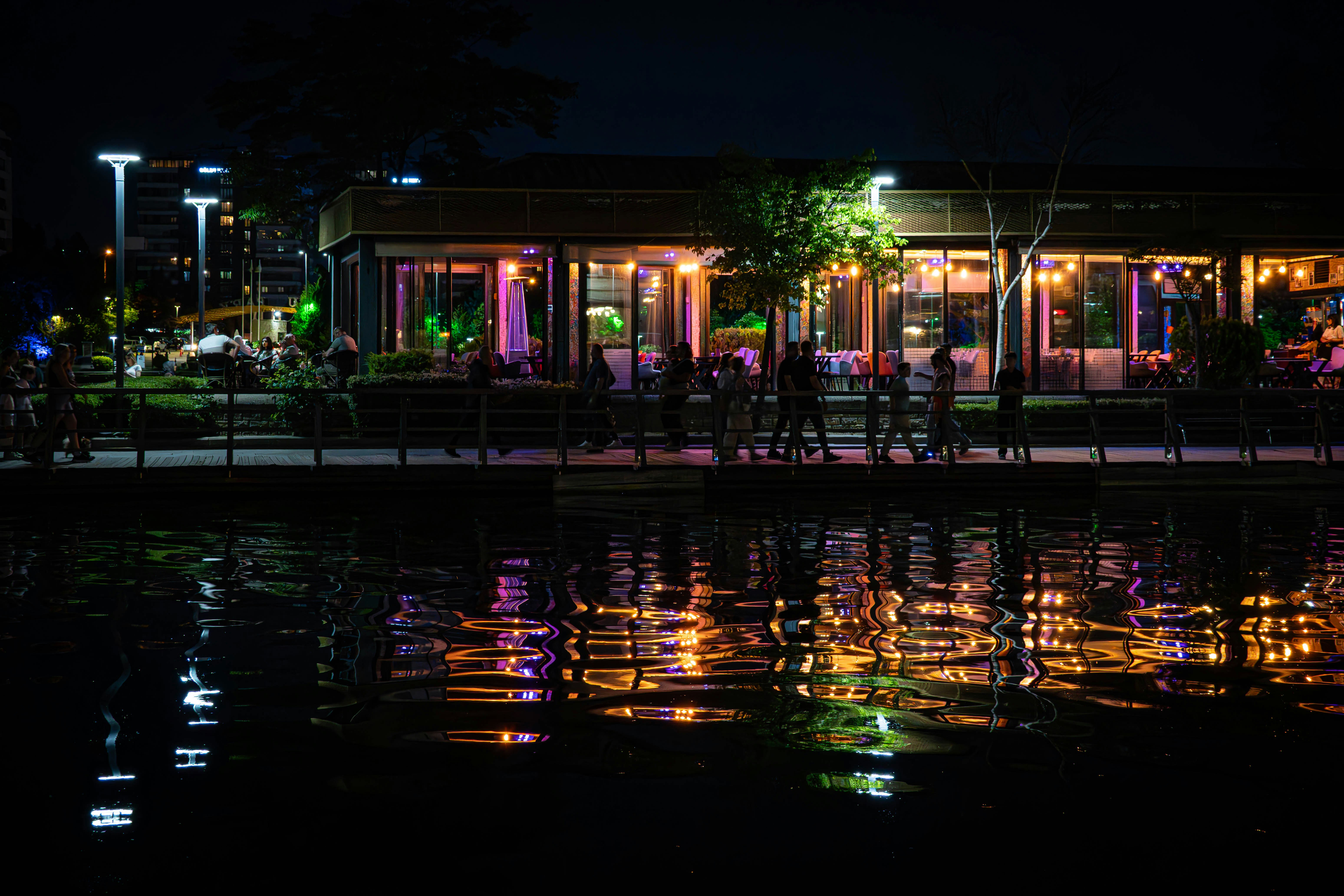 Lit building reflected on water at night