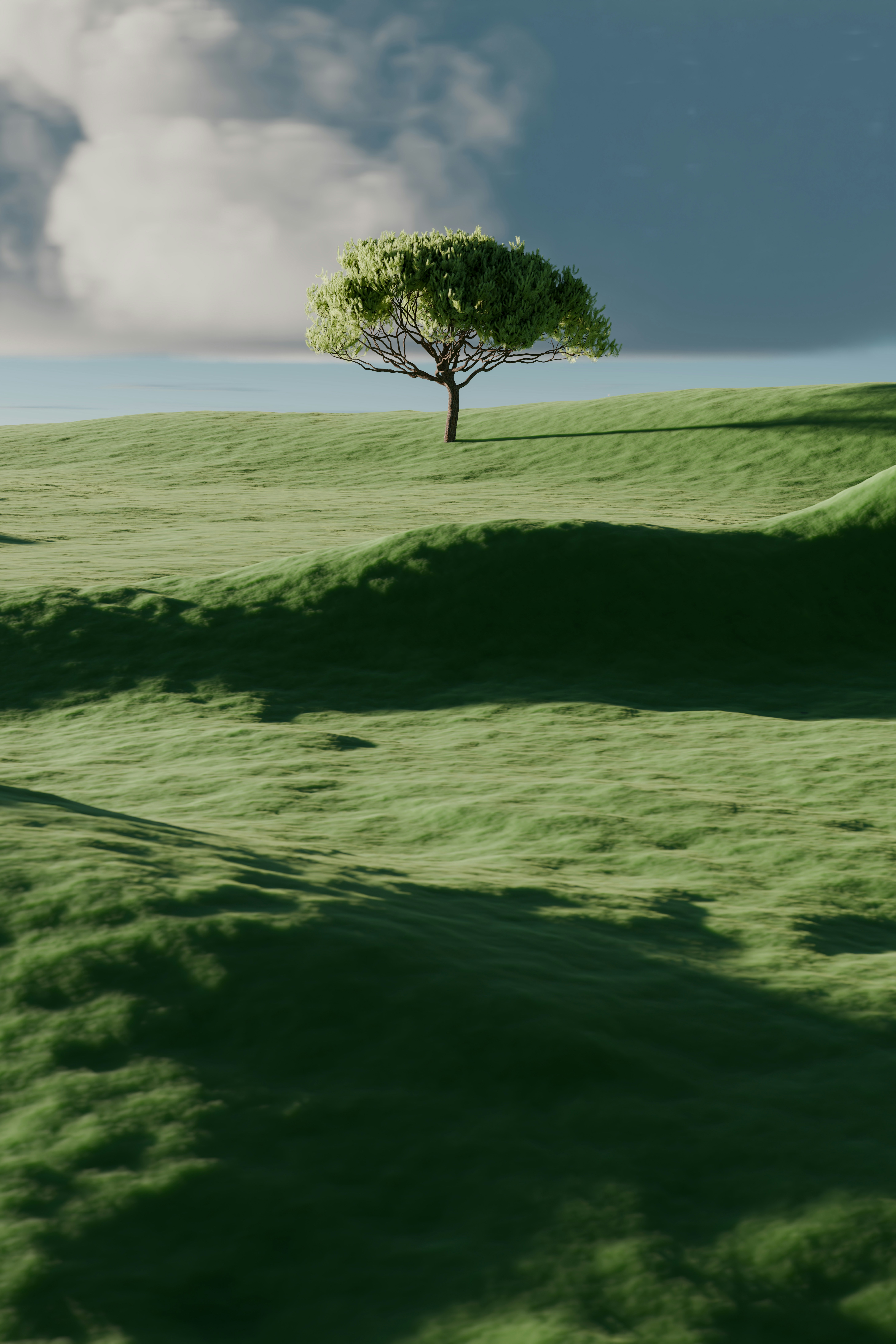 A single tree on a vibrant green rolling hill.