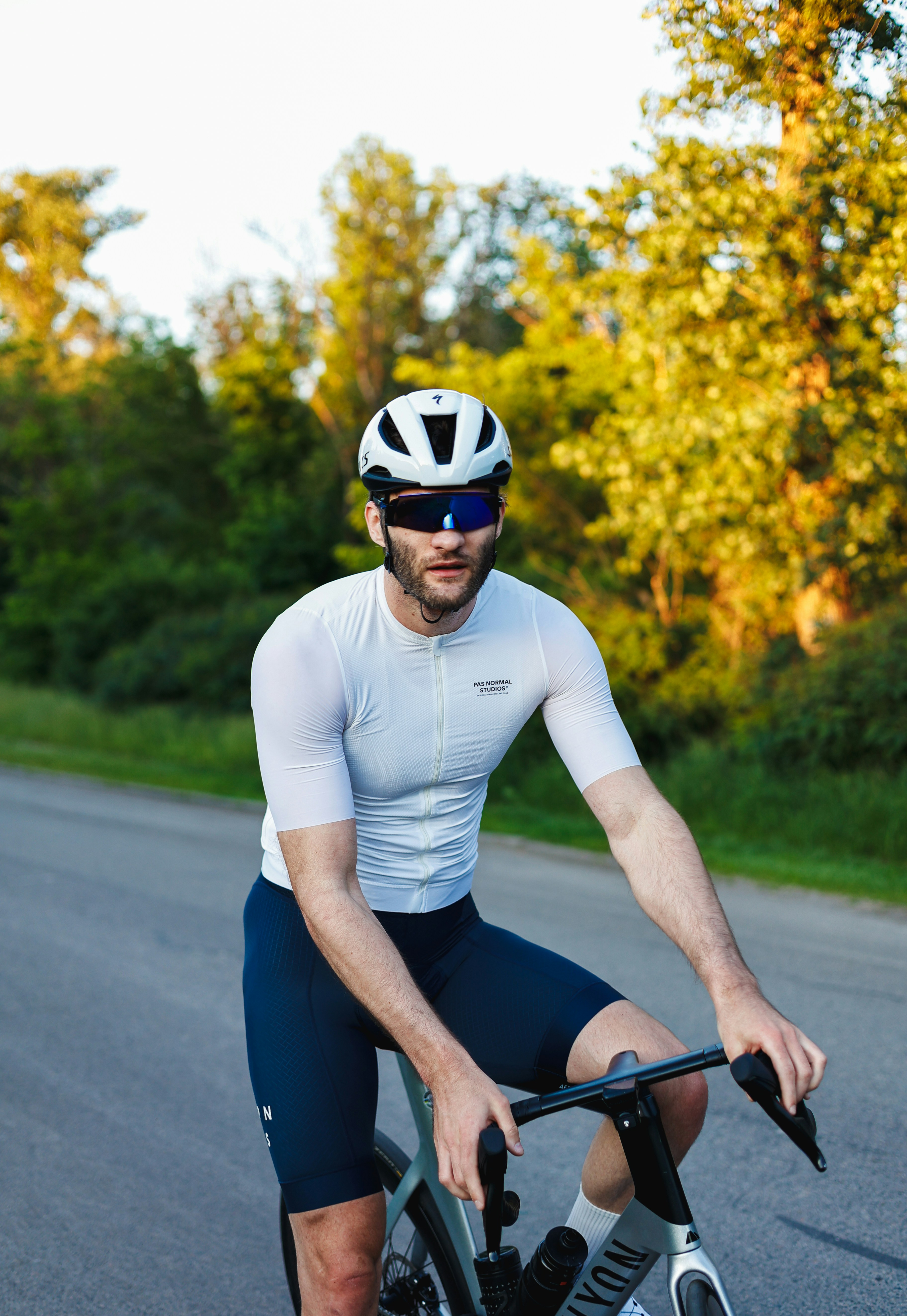 Cyclist wearing helmet and sunglasses on a road