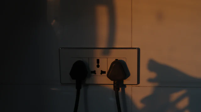 Power plugs connected to a wall socket