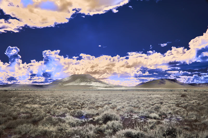 surreal desert landscape with vibrant clouds and distant mountains