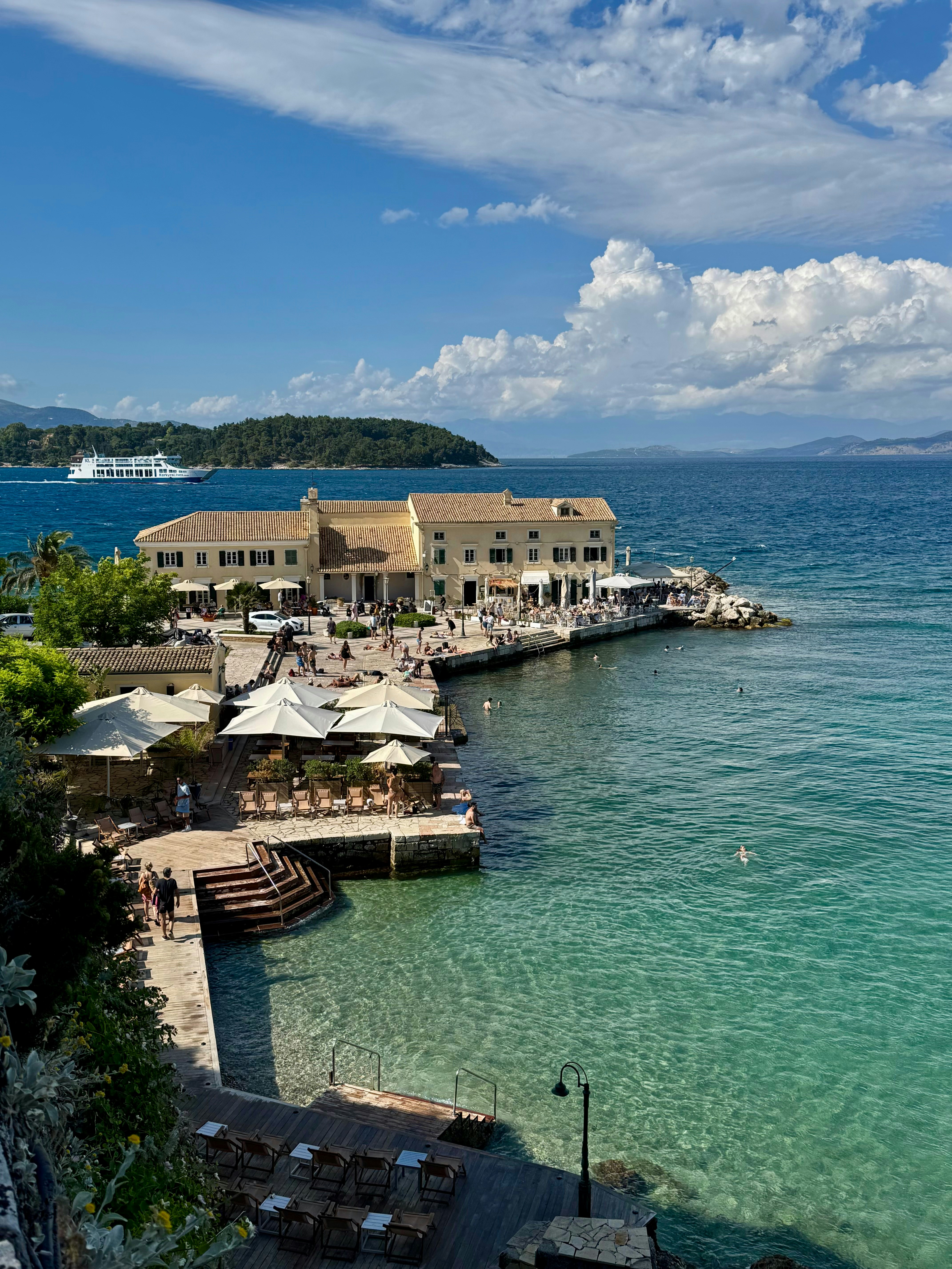 Coastal building and cafes by the clear turquoise sea