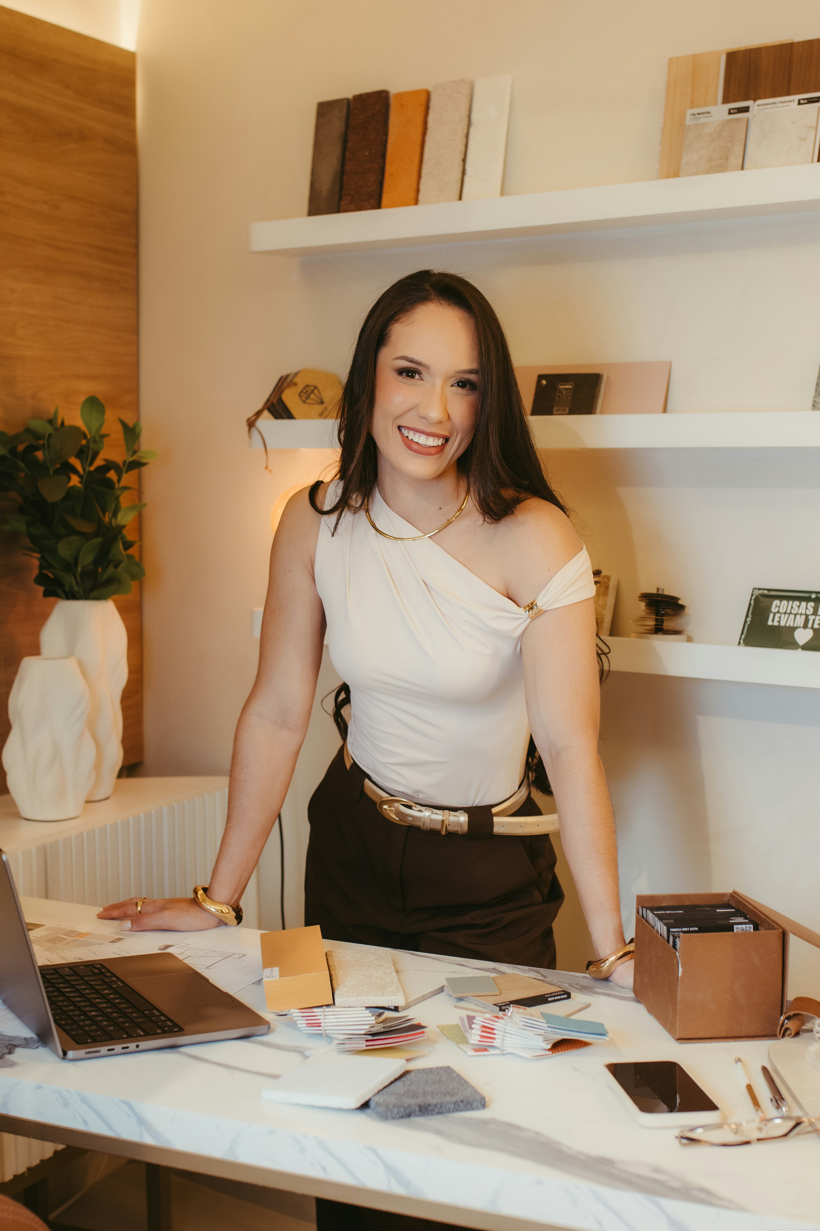 Creative professional working with design samples at a studio desk