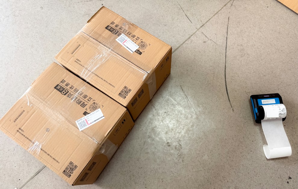 Brown shipping boxes next to a small label printer