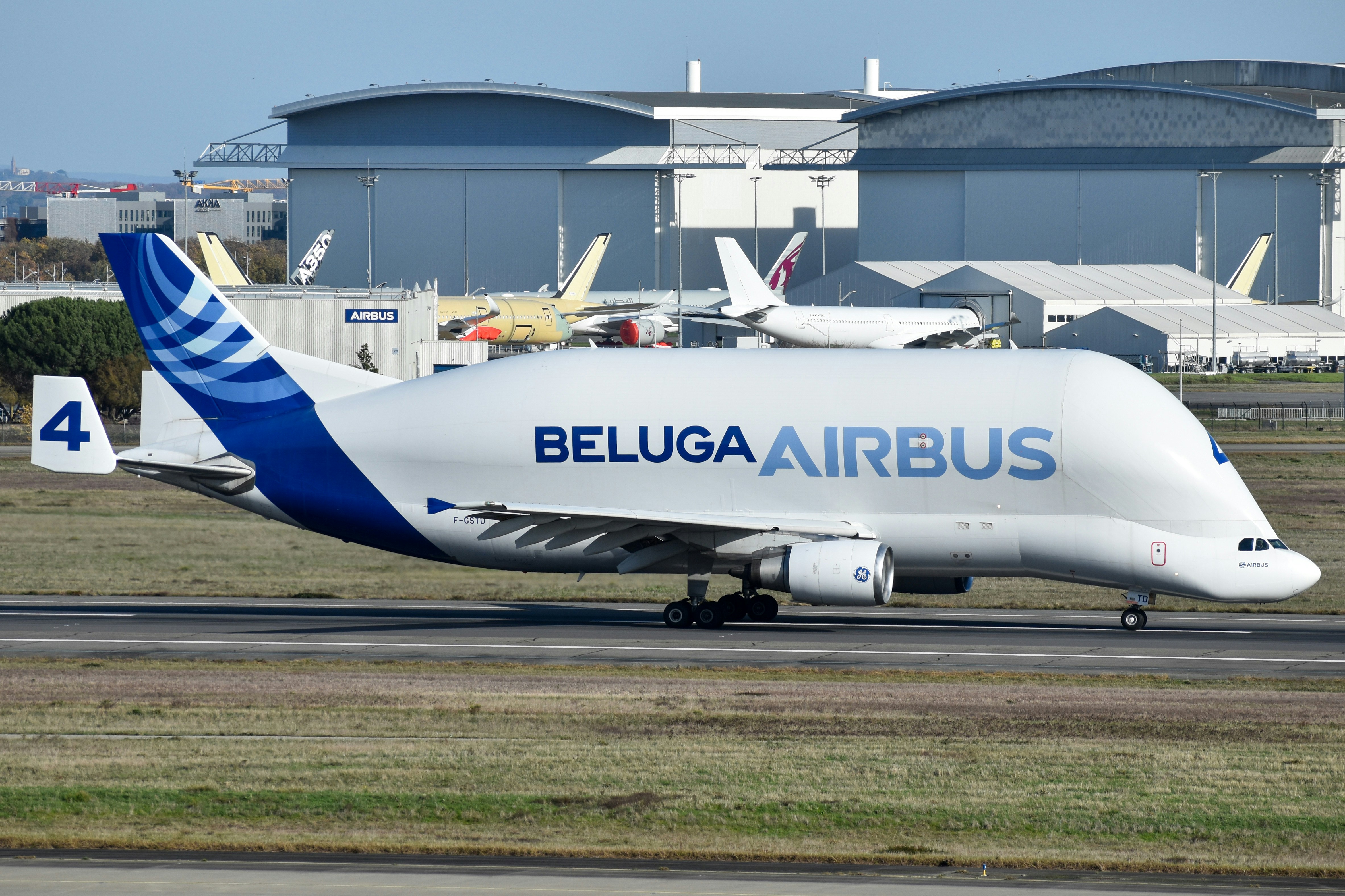 A white airbus beluga cargo plane on a runway.