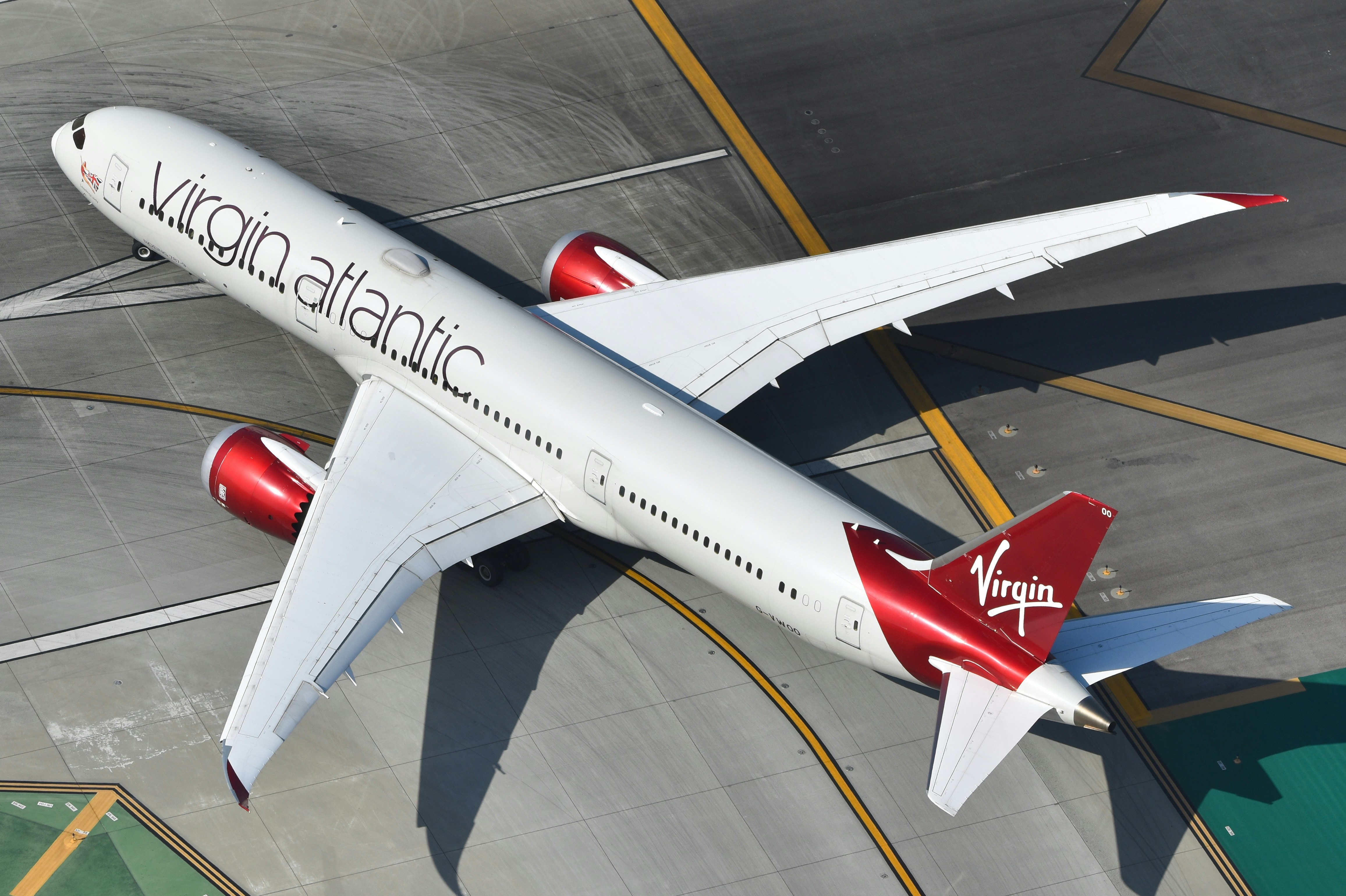 A virgin atlantic airplane on an airfield from above.