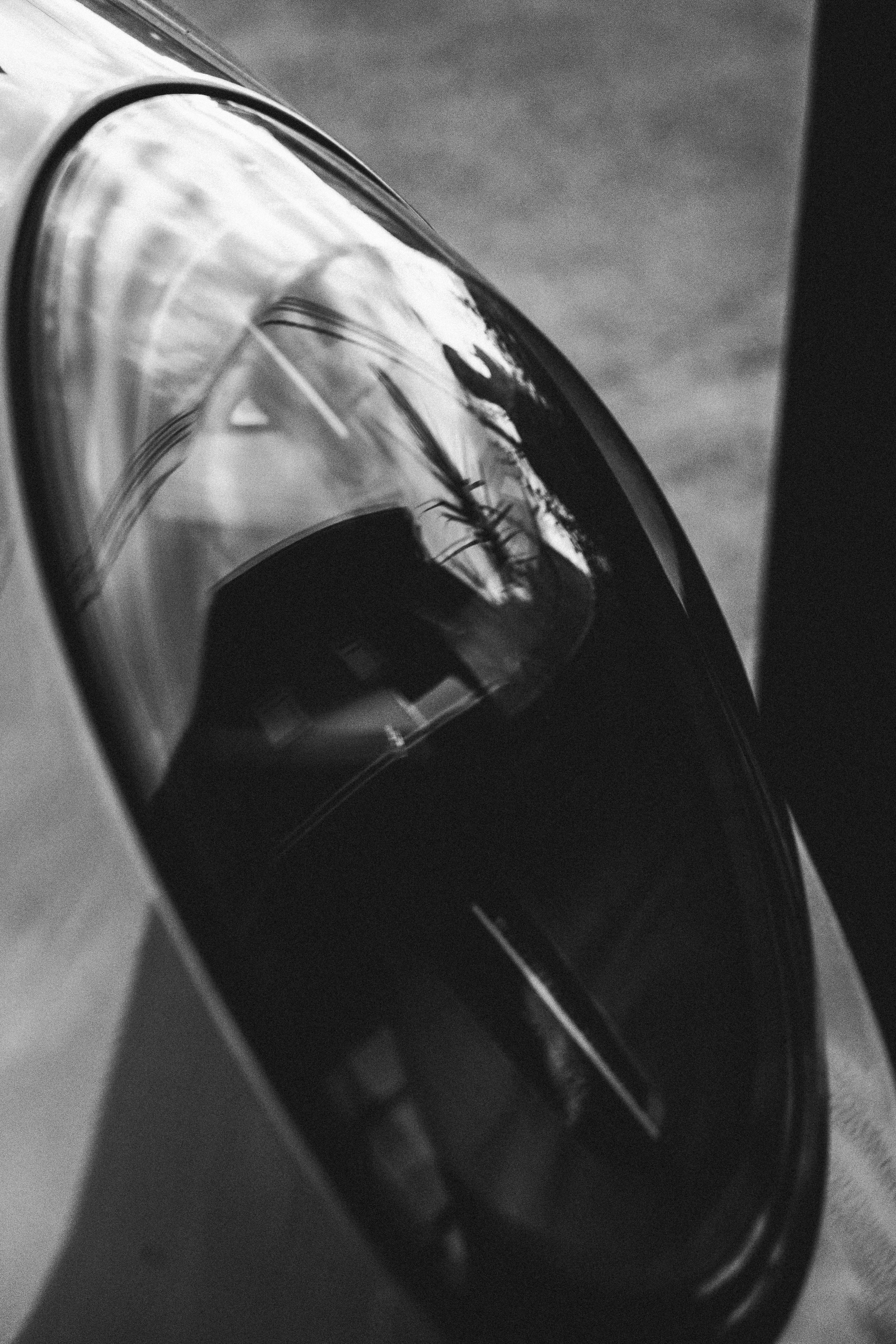 Glossy, reflective oval object in black and white
