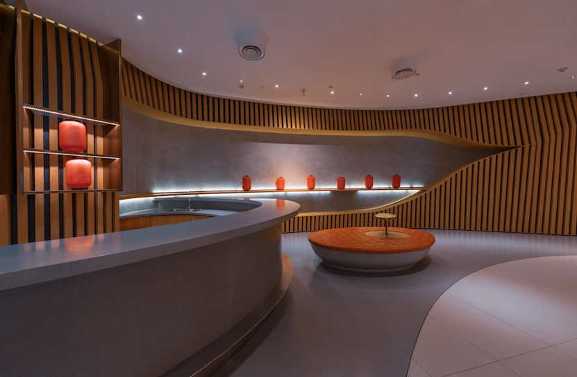 Modern lounge with curved wooden walls and orange decor