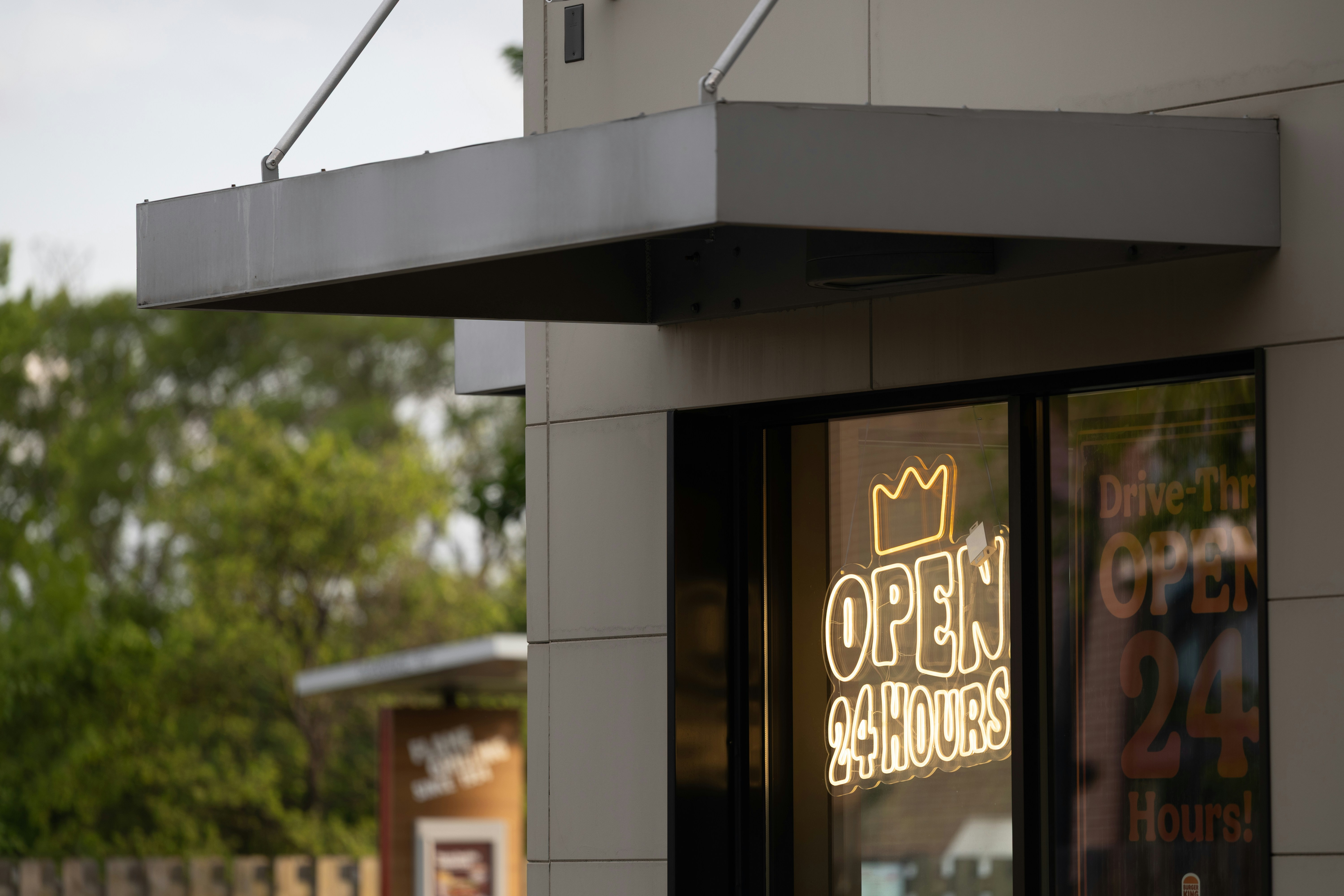 Neon "open 24 hours" sign in a building window