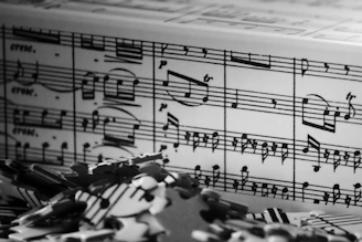 Black and white sheet music with scattered puzzle pieces