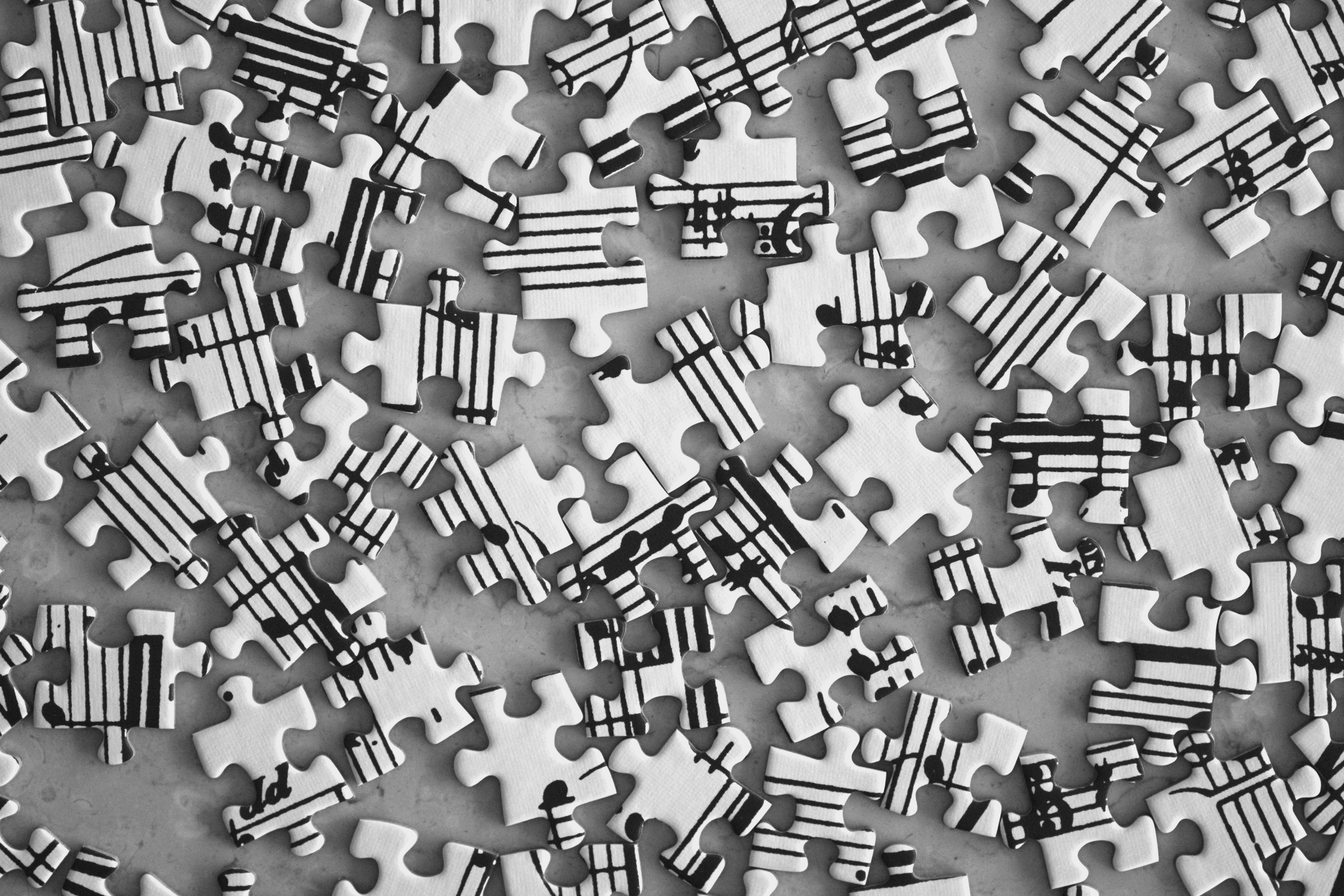 Scattered jigsaw puzzle pieces with musical notes