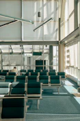 Modern airport waiting area with empty seats and sunlight