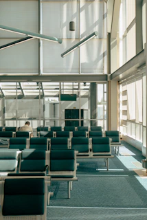 Modern airport waiting area with empty seats and sunlight