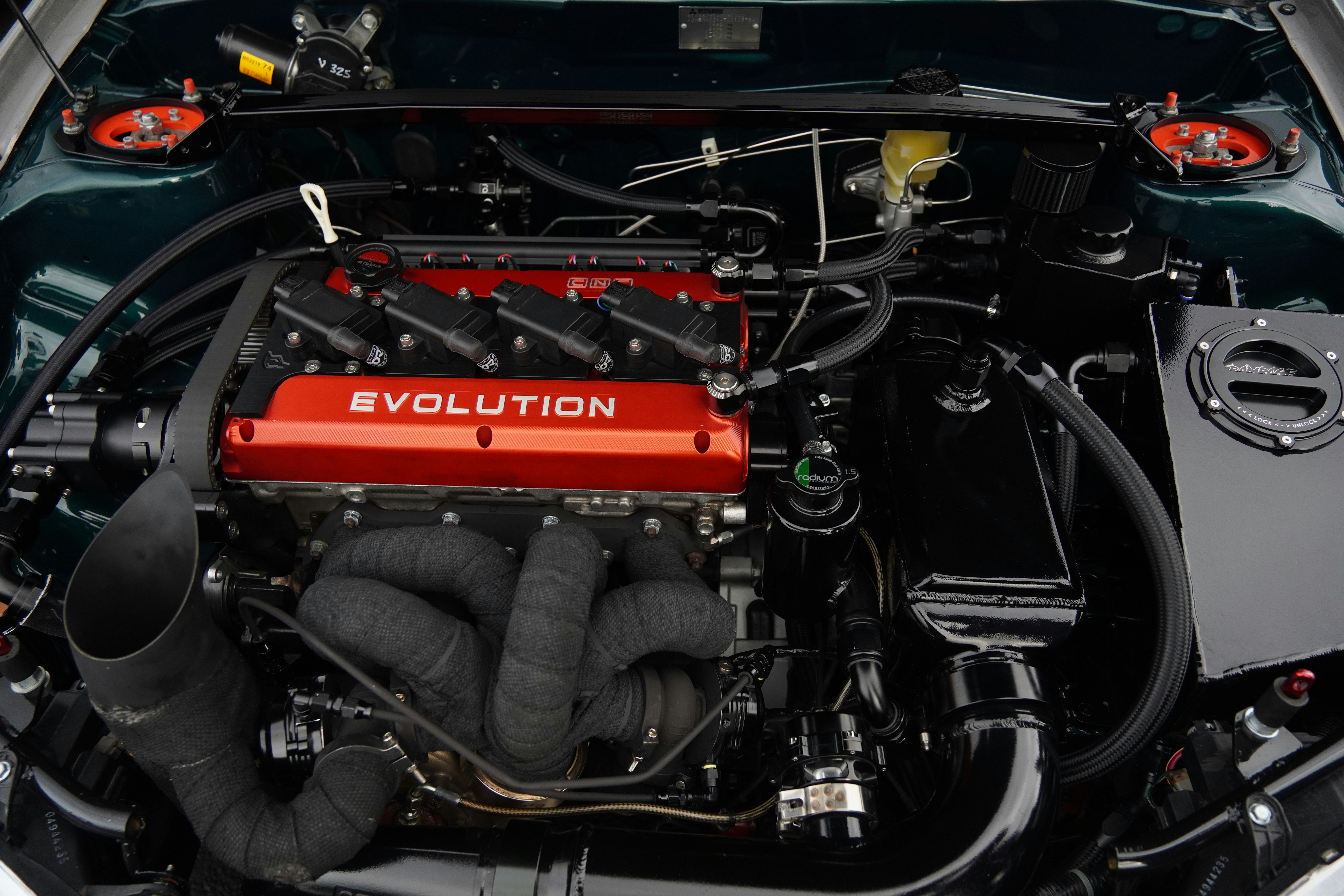 A powerful car engine with a red evolution cover.