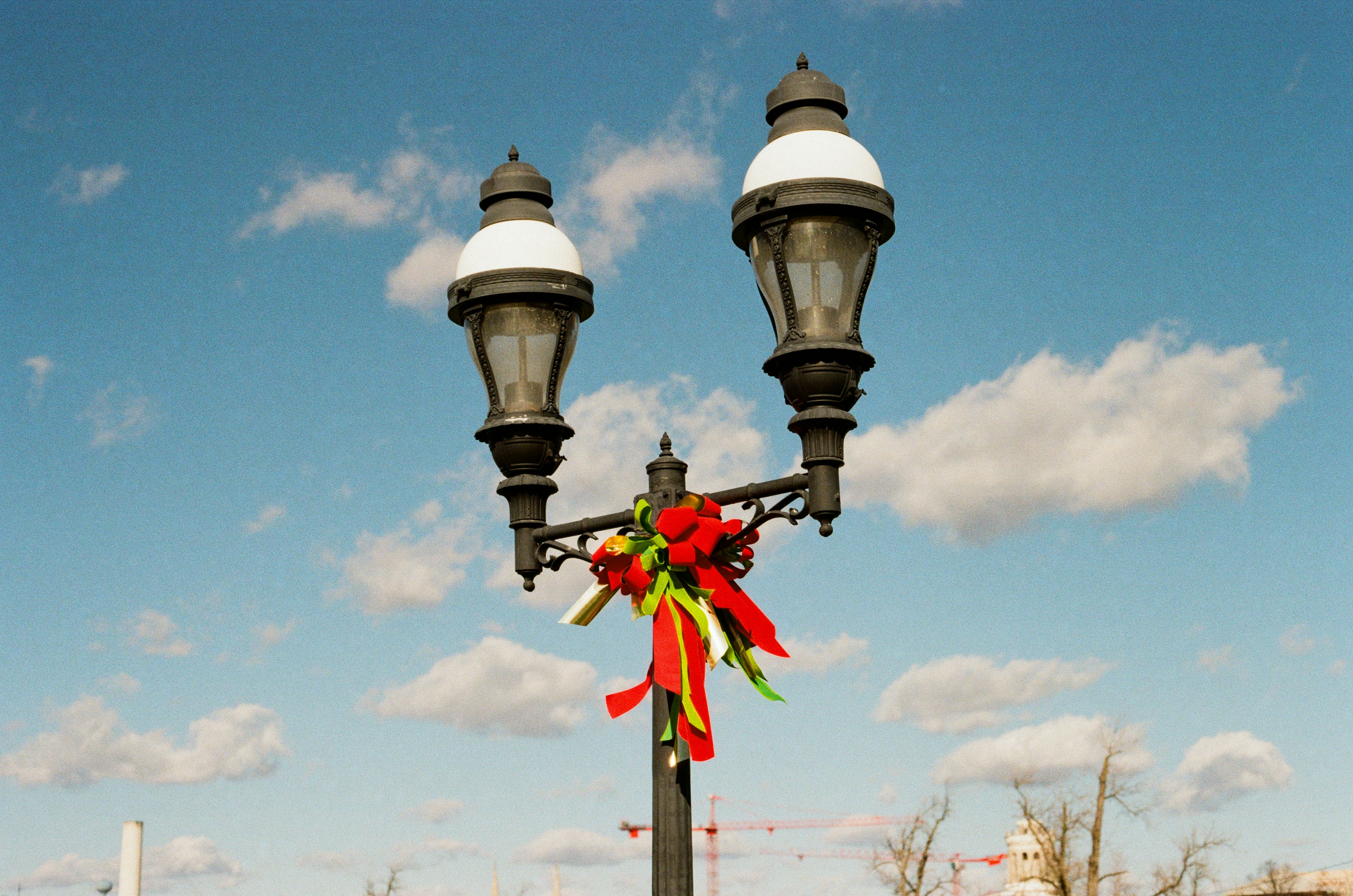 Decorated street lamp under a bright blue sky