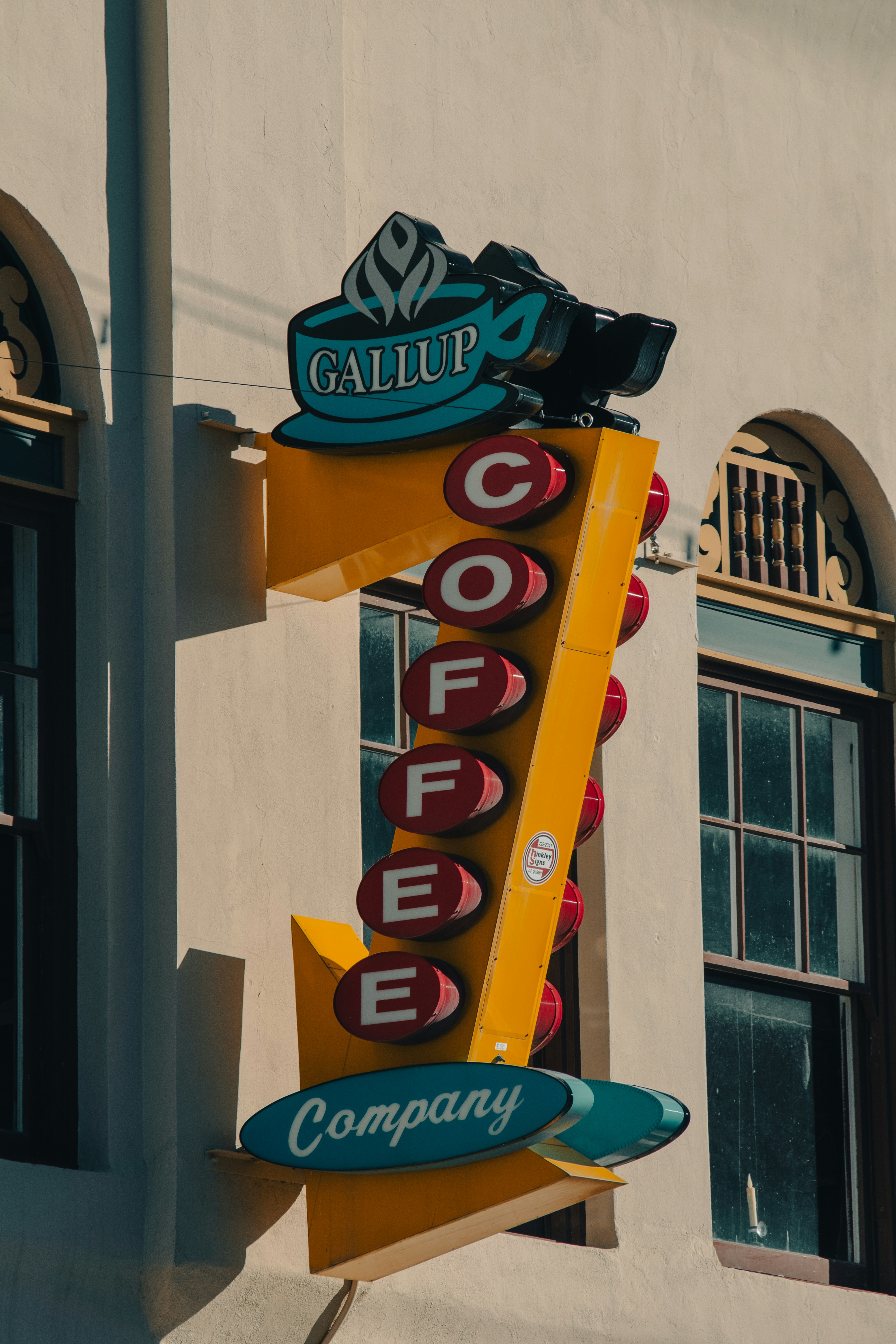 A vintage yellow sign for gallup coffee company