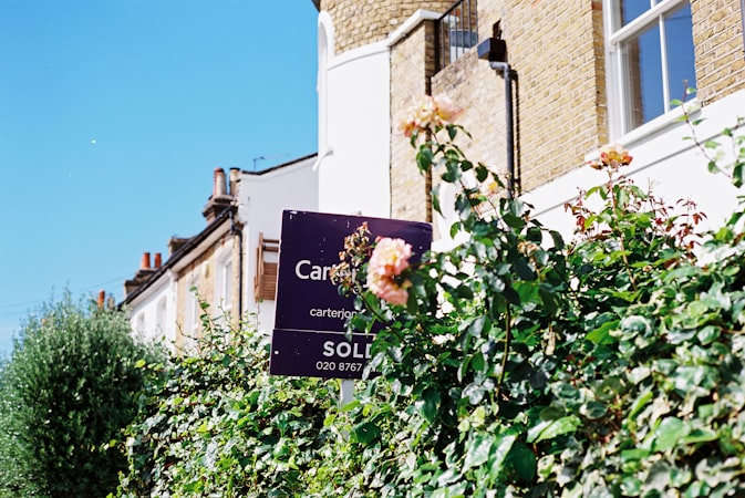 A sold sign in front of a house, representing recent closings that set the median sale price Redfin tracks each week