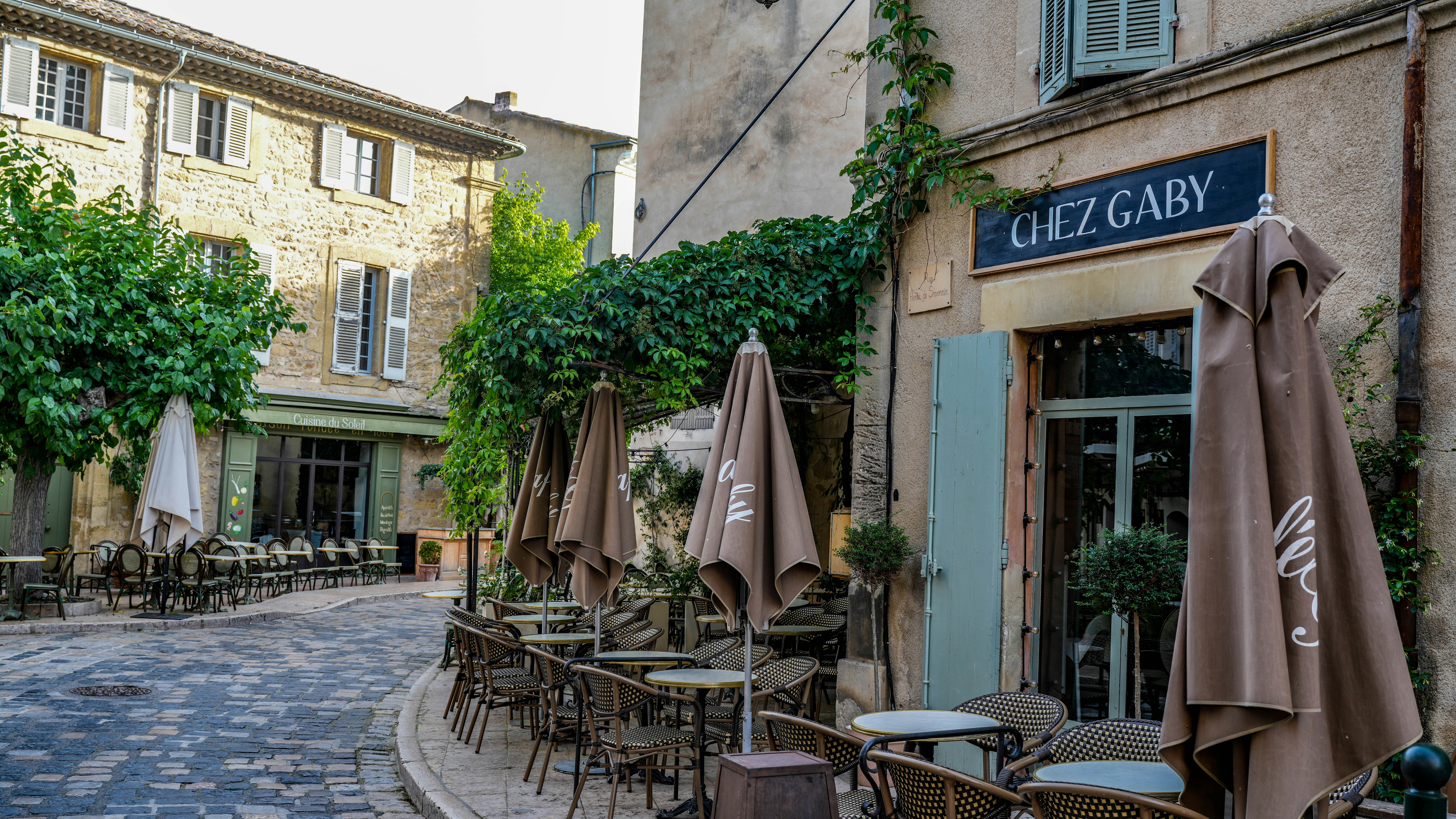 An outdoor cafe with umbrellas on a charming european street.