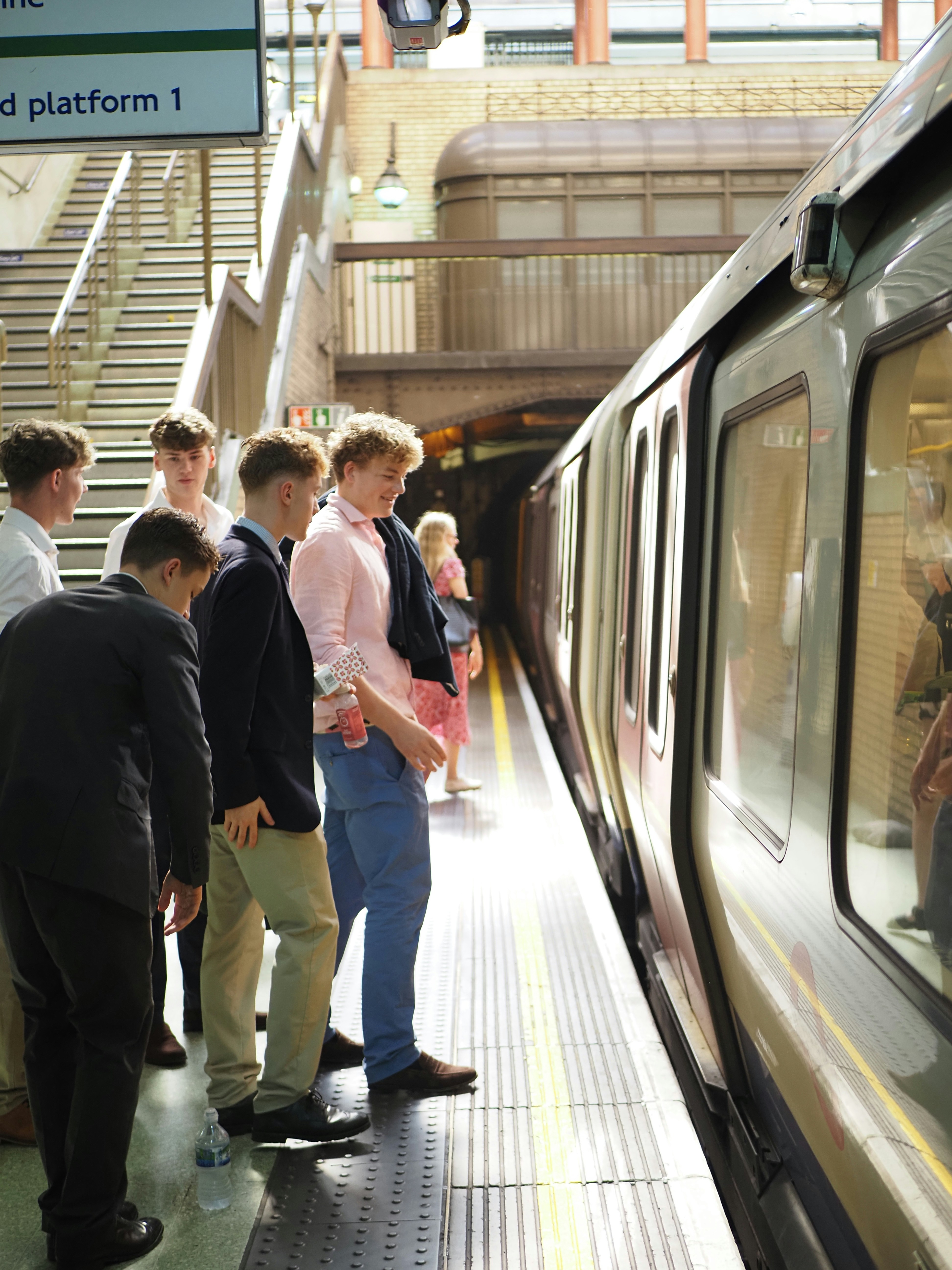 Young men waiting for a train at an underground station