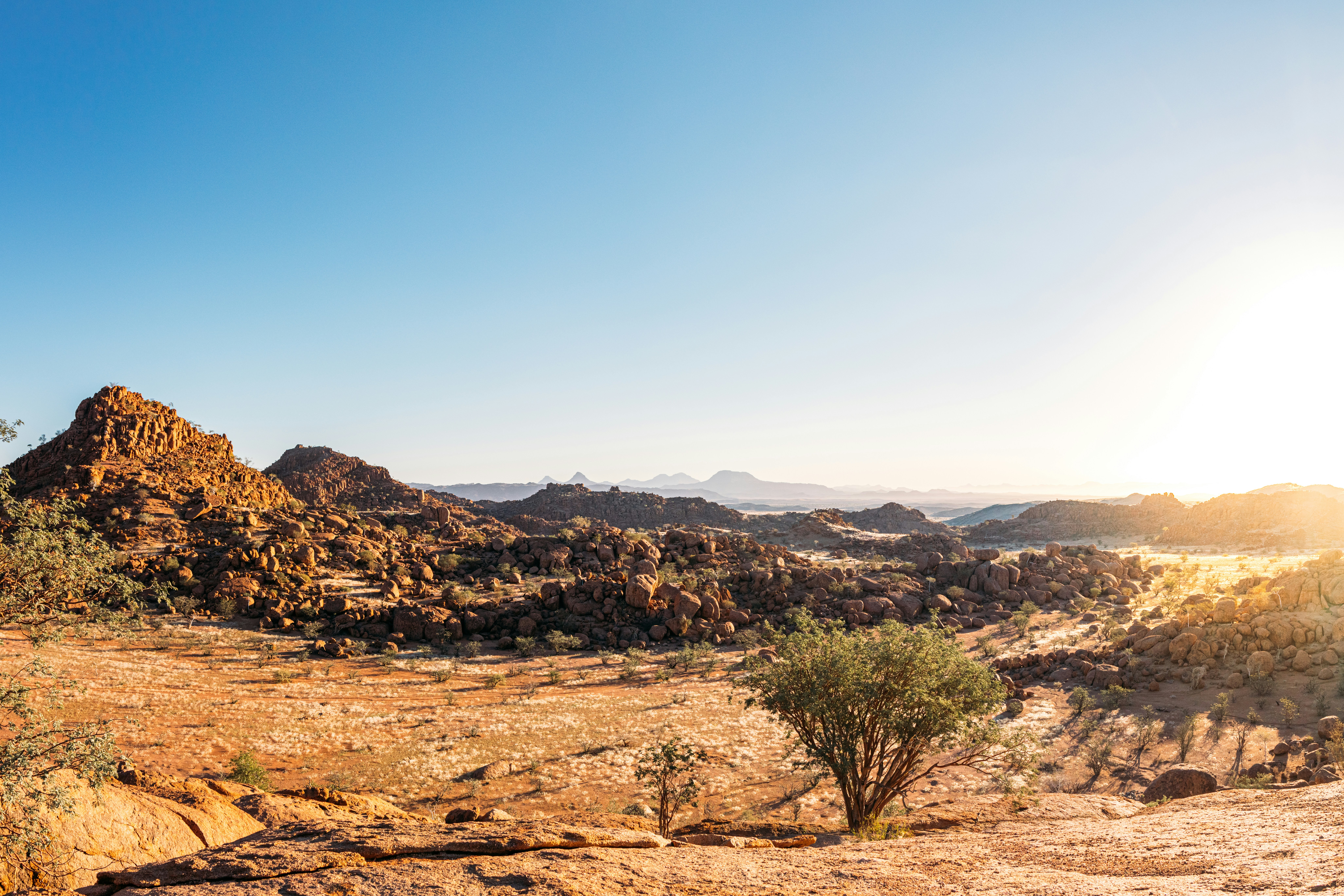 Desert Landscape with Rocky Mountains and a Bright Sun