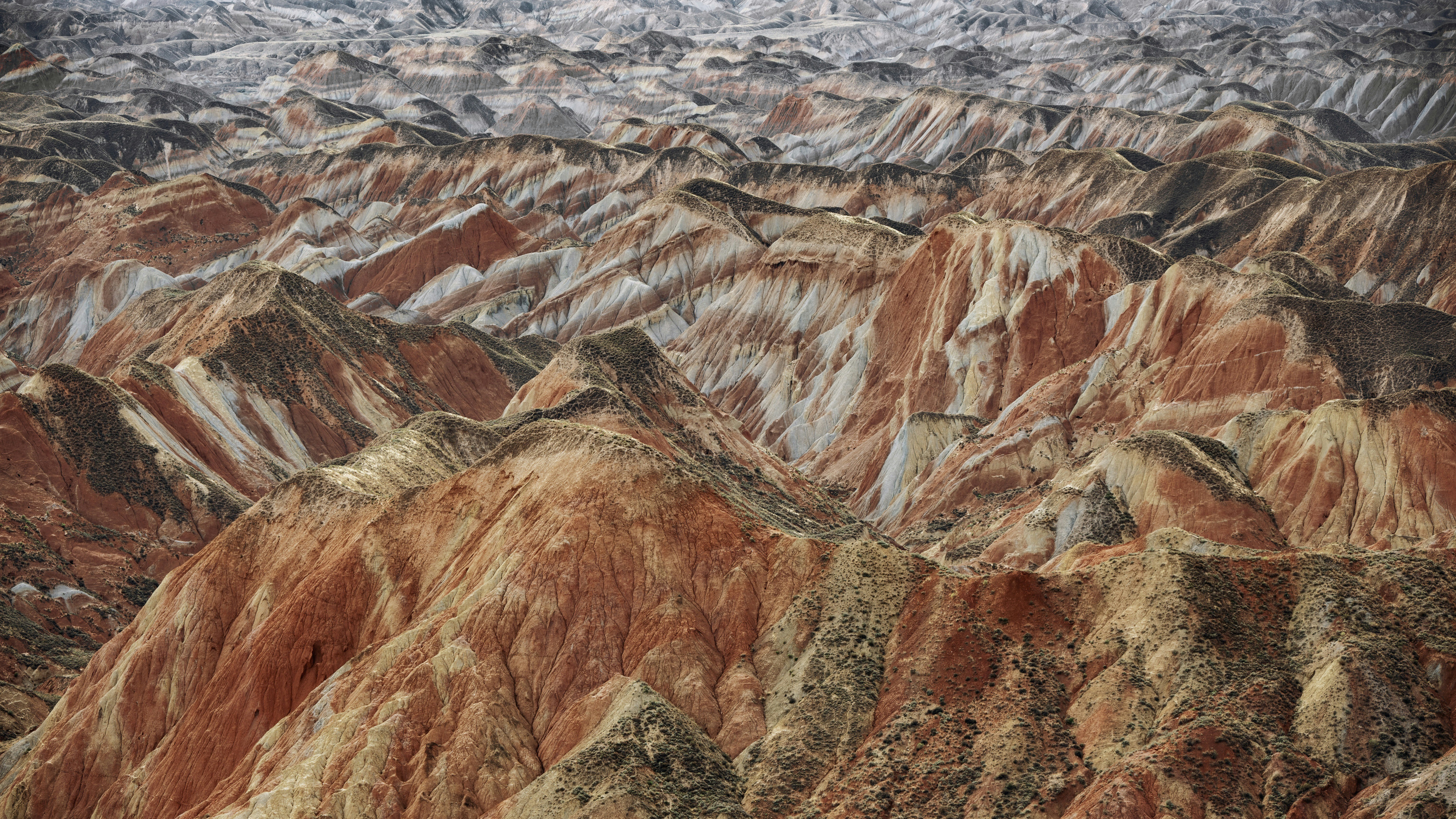 Vibrant striped danxia mountains create a unique geological landscape.