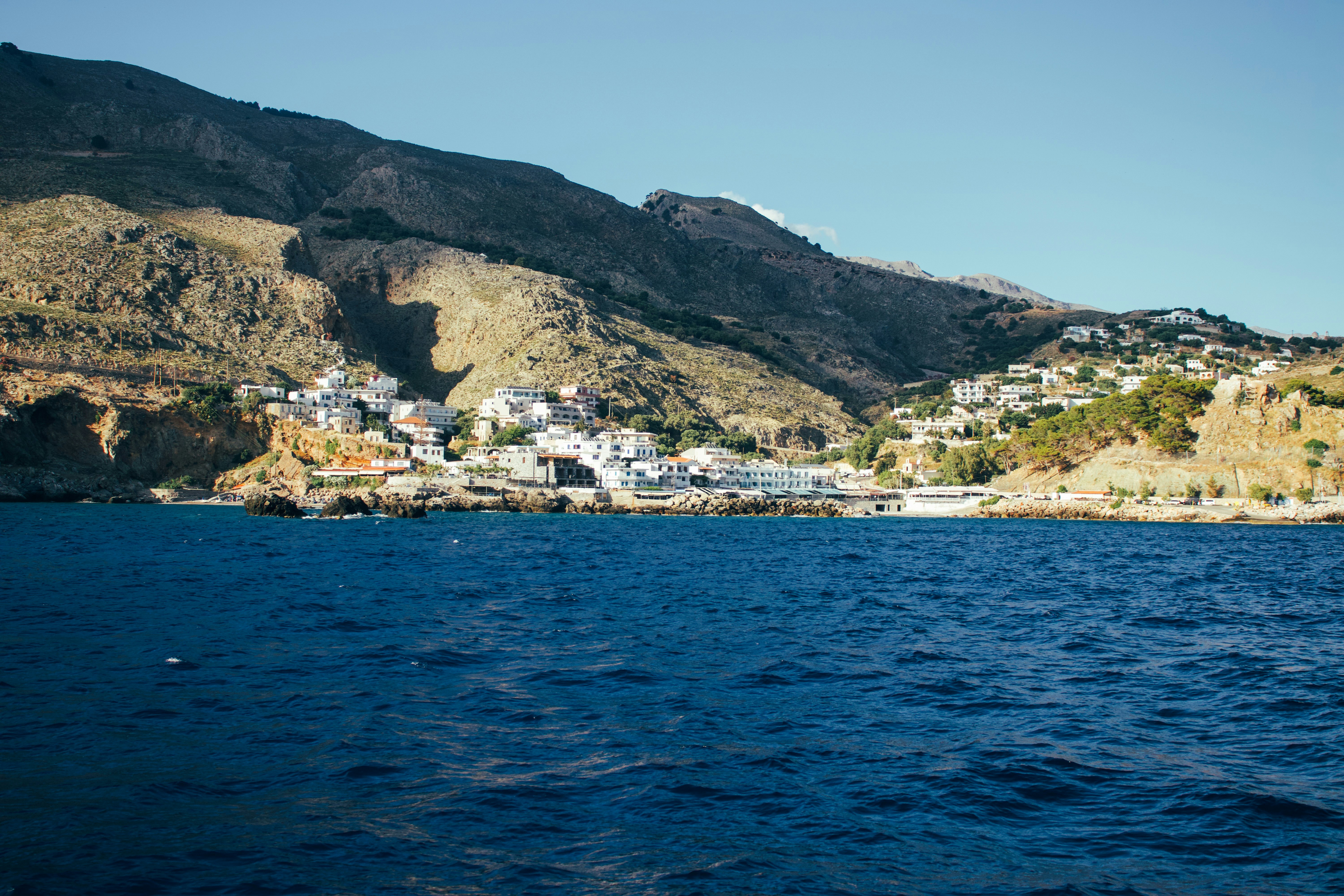 A coastal town nestled between mountains and the blue sea