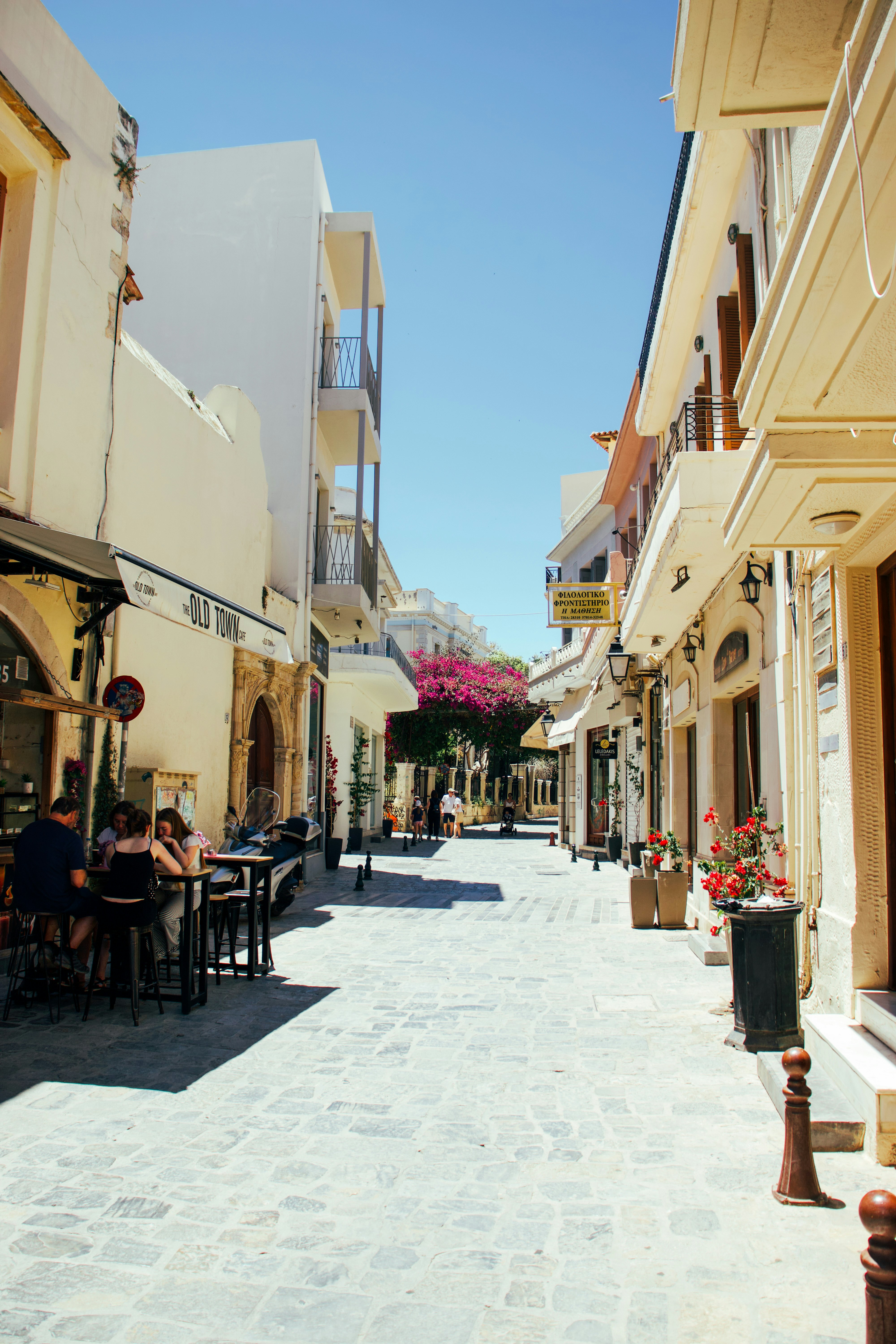A charming narrow street with outdoor cafes and old buildings