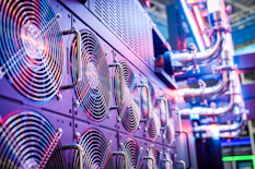 Close-up of server cooling fans in a vibrant data center.