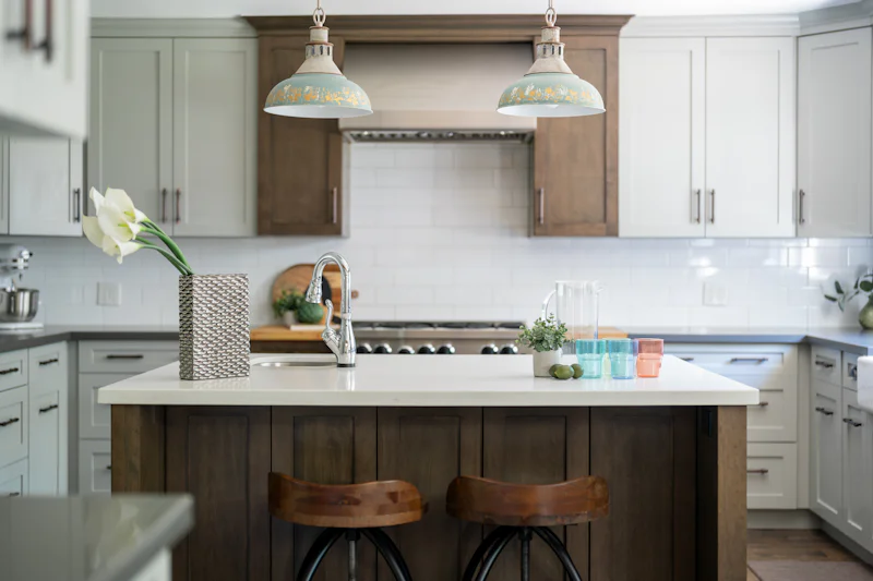 Kitchen with an island, bar stools, and pendant lights