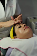 Woman receiving a facial treatment at a spa.