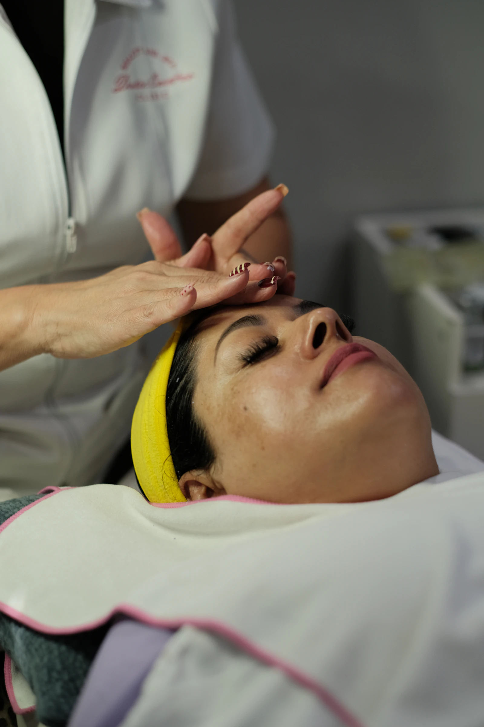 Client relaxing during a professional facial treatment