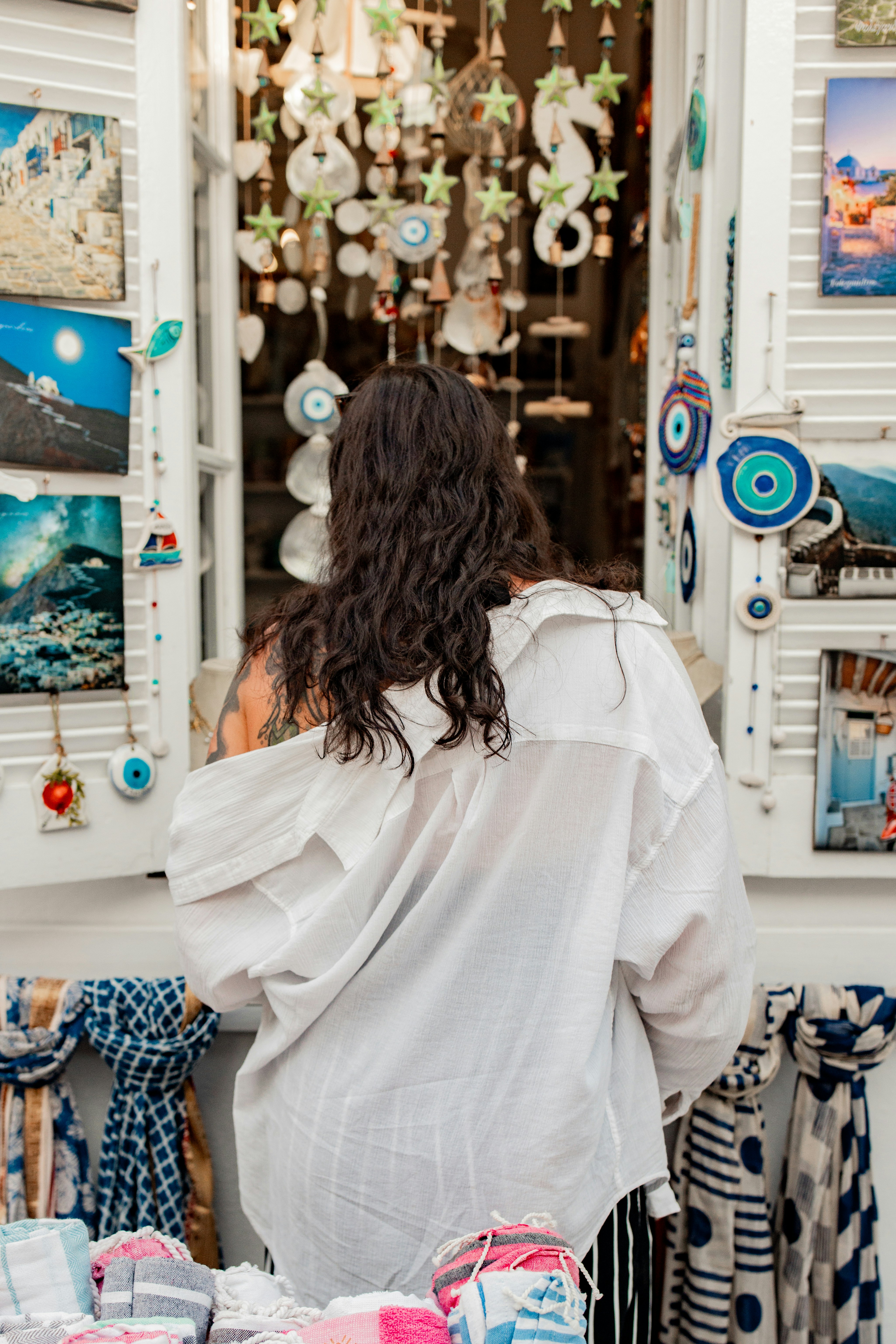 Woman browsing souvenirs in a shop window