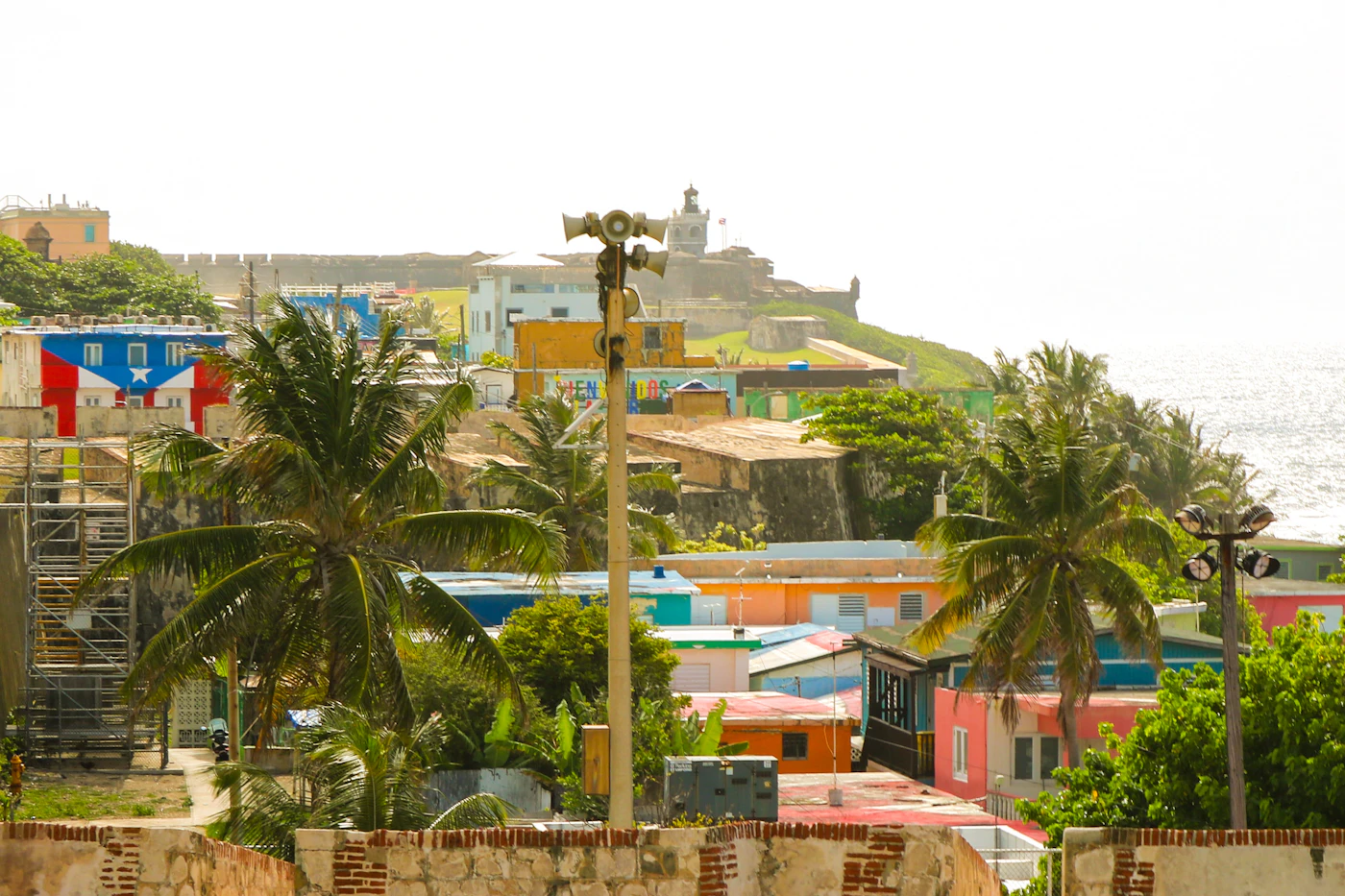 Colourful colonial buildings and a fort wall in Old San Juan, Puerto Rico, overlooking the Caribbean Sea, where the region's banking and insurance leaders meet each November