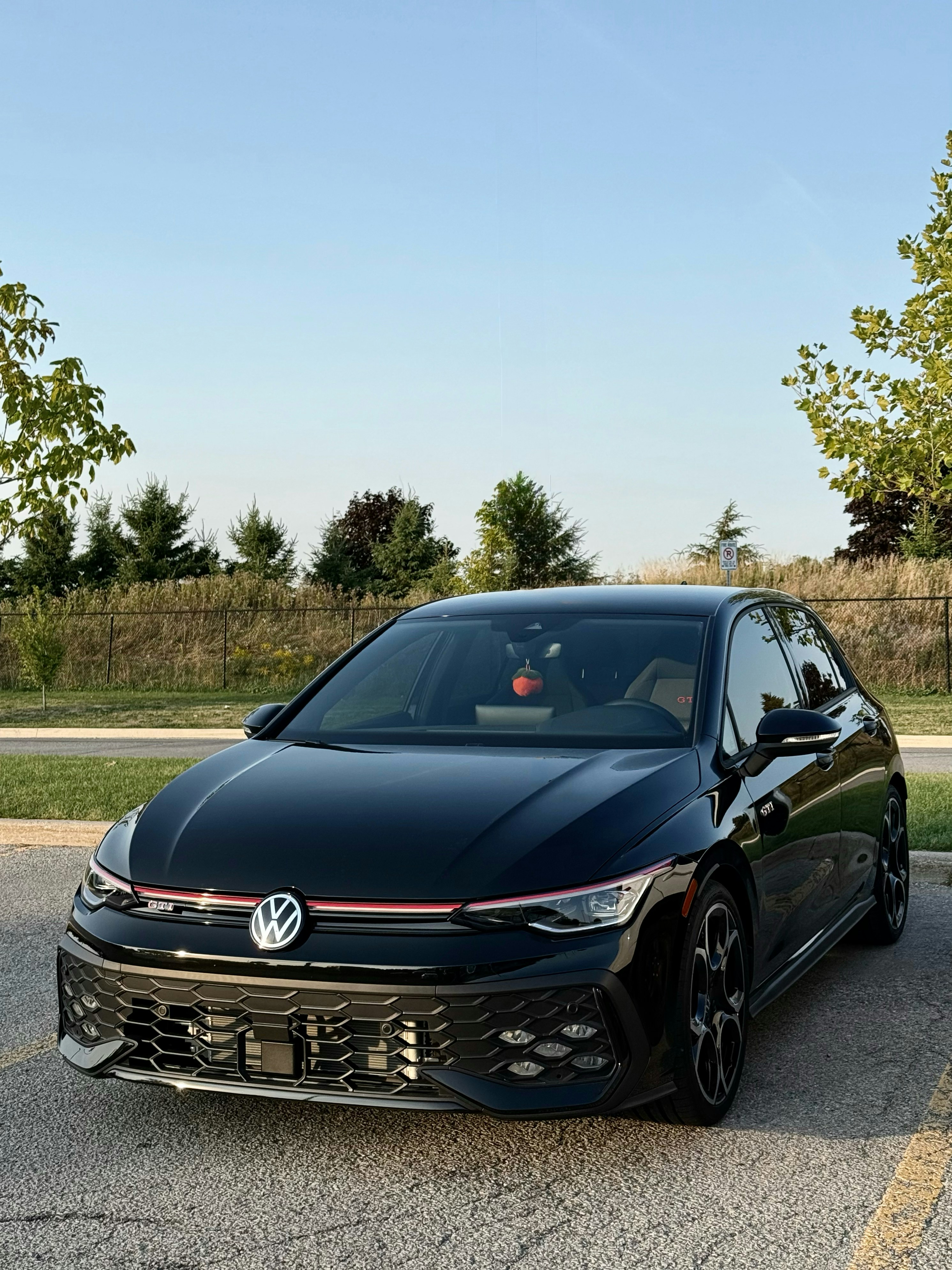 Modern black volkswagen golf gti parked outdoors.