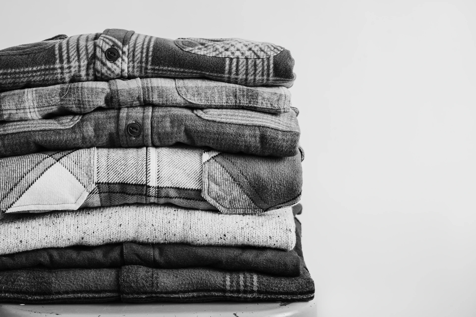 A stack of folded shirts in black and white