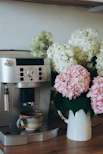 Espresso machine with coffee cup and hydrangeas