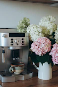 Espresso machine with coffee cup and hydrangeas