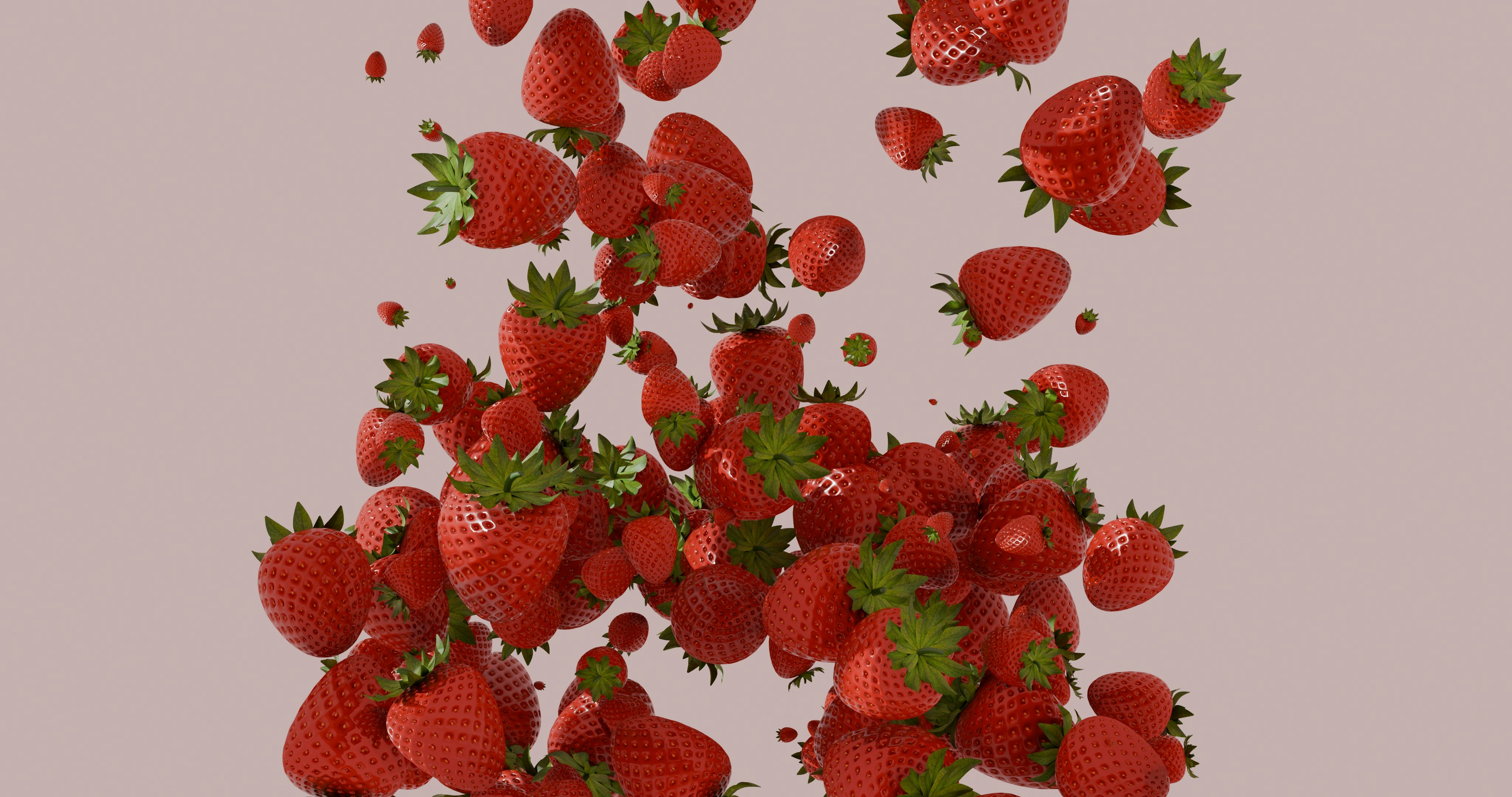 De nombreuses fraises rouges fraîches tombant sur un fond rose clair.