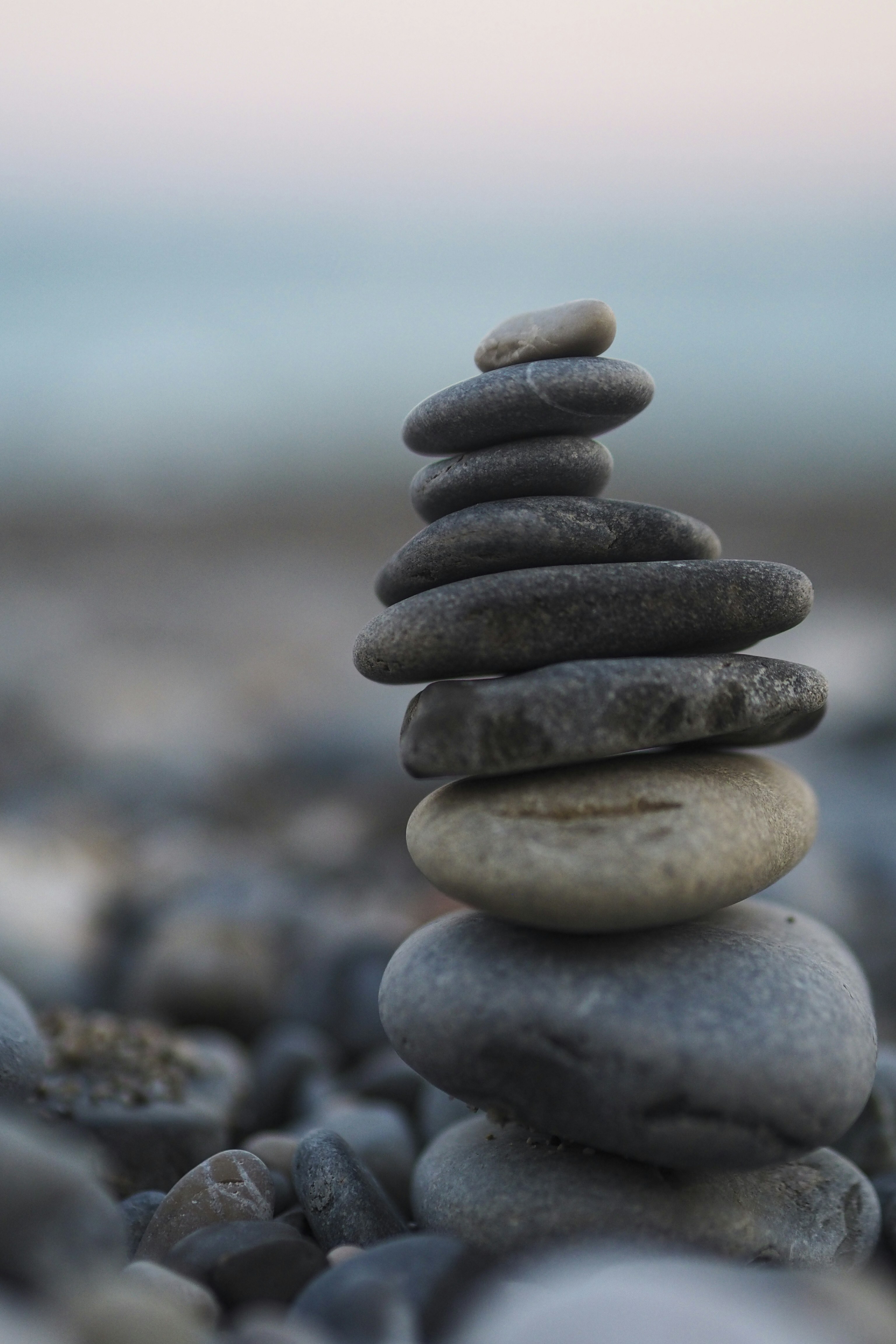 Stack of balanced stones on a pebbly beach