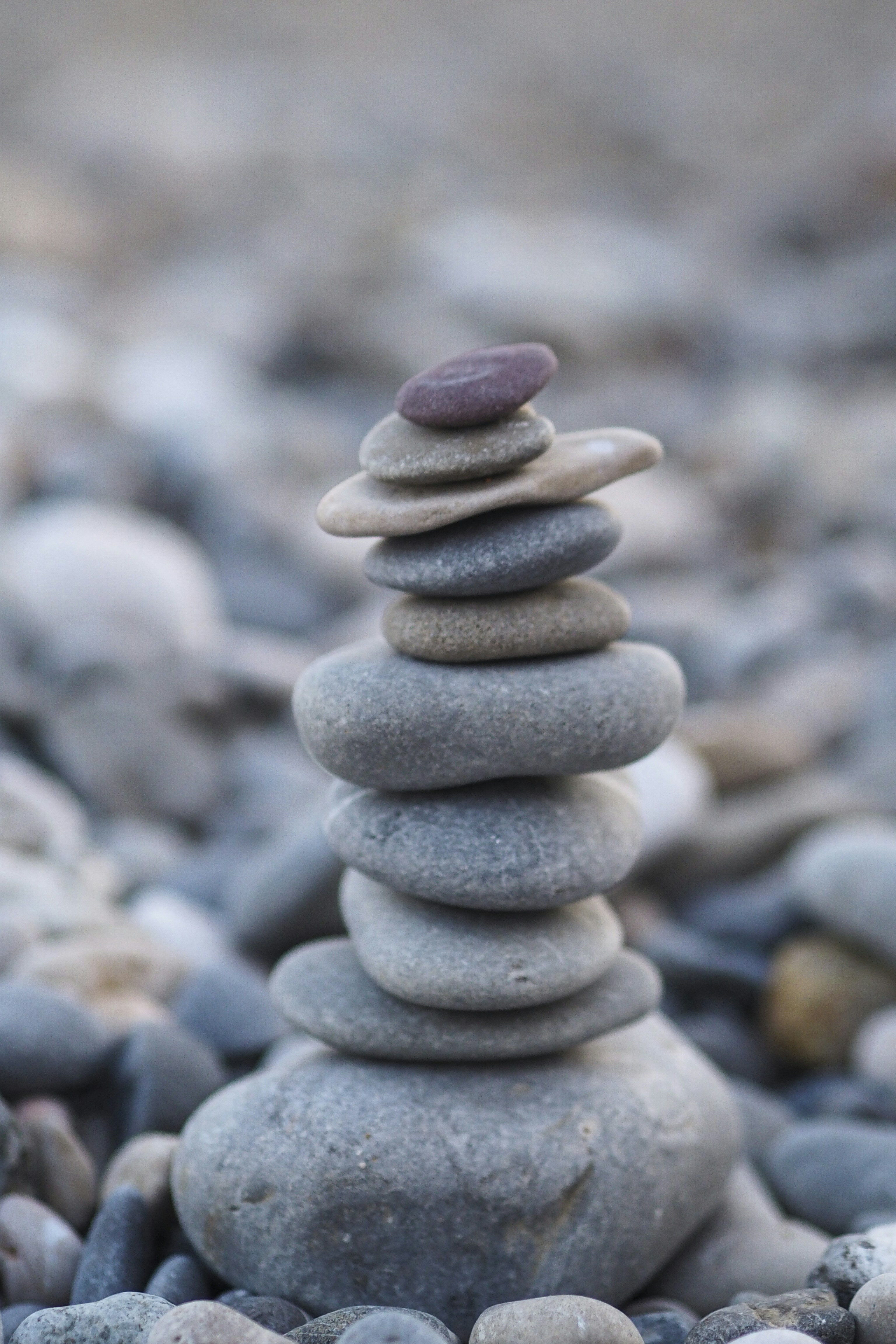 A stack of balanced zen stones on a rocky beach