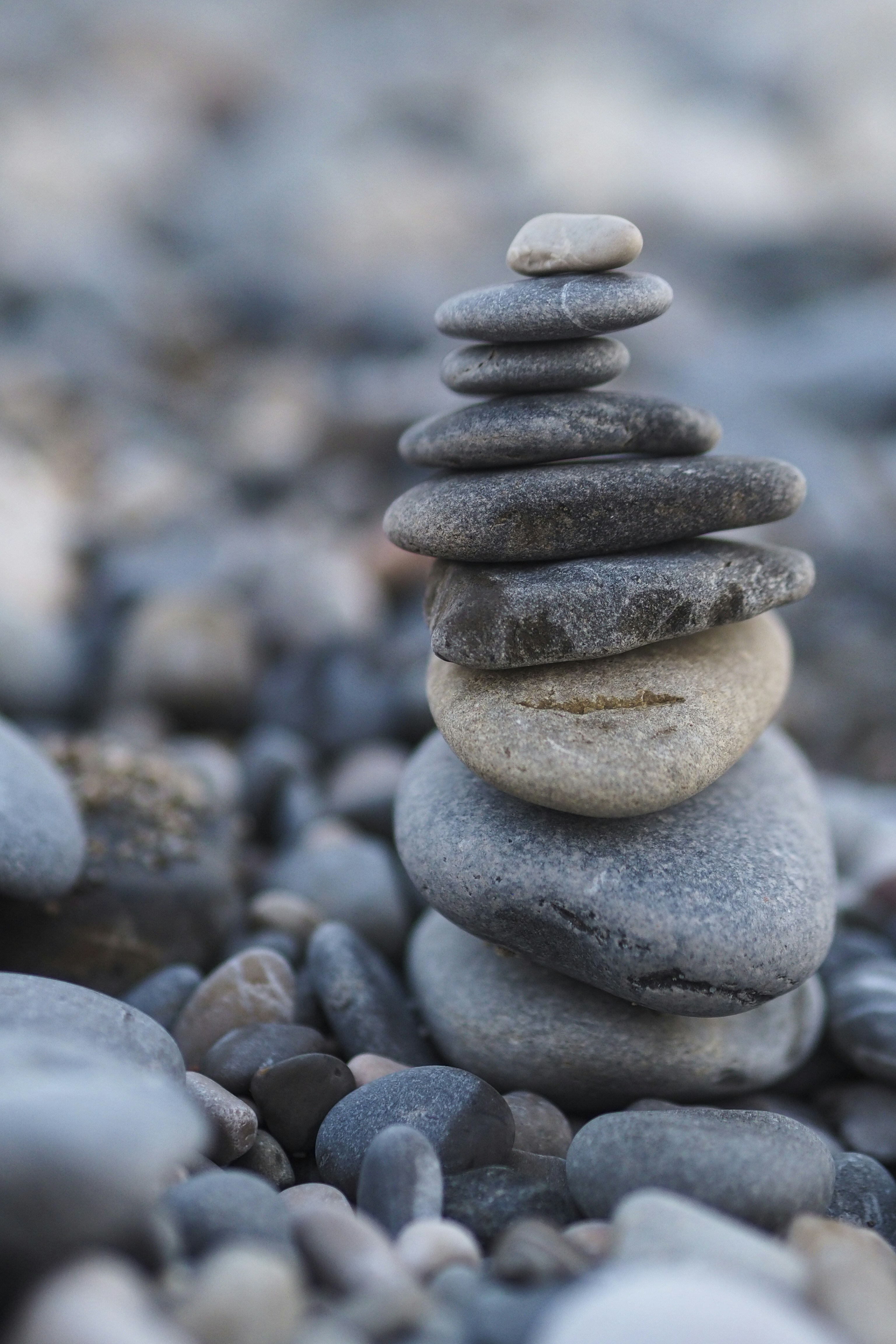 A stack of balanced grey and beige rocks.