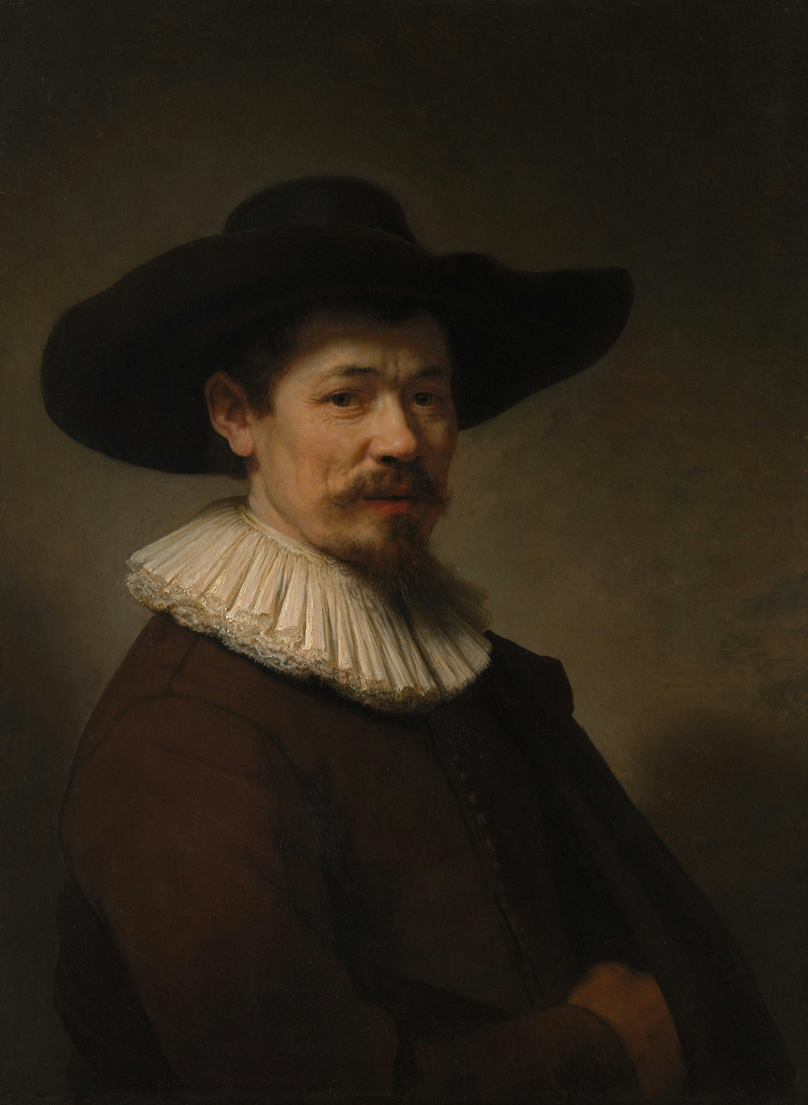 A man in a wide-brimmed hat and ruffled collar