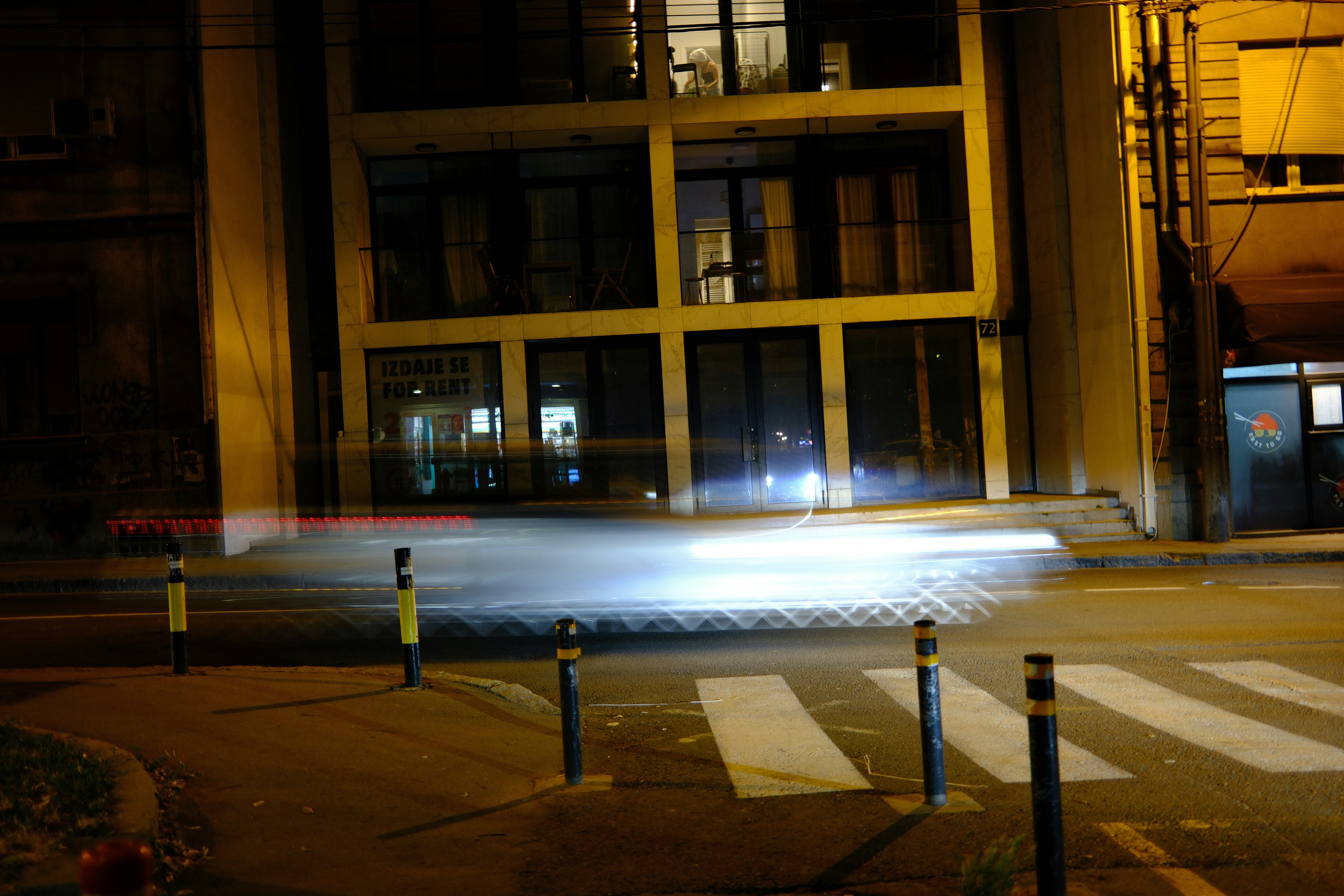 Vehicle light trails on a dark city street at night.