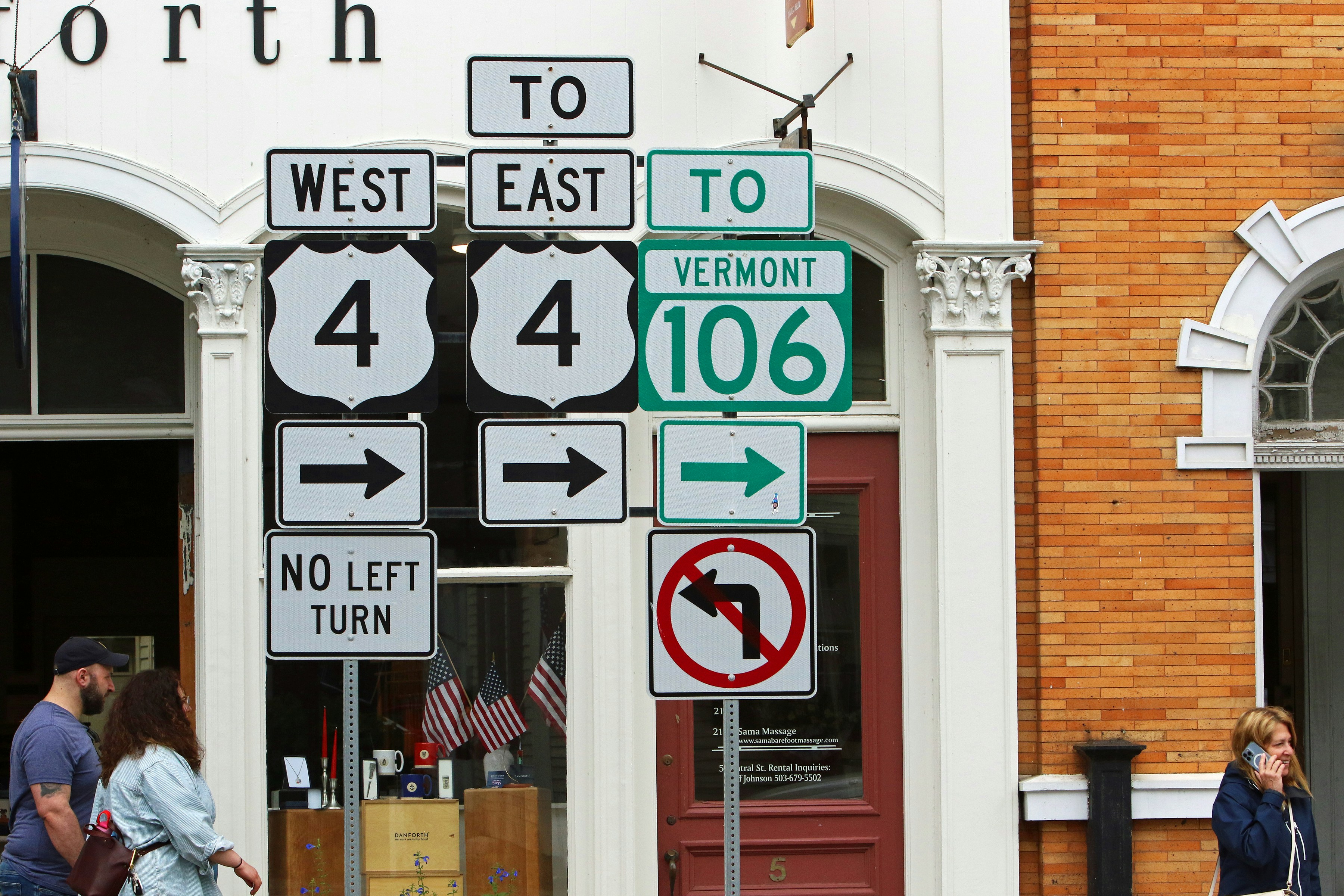 Numerous road signs indicating directions and routes on a street.