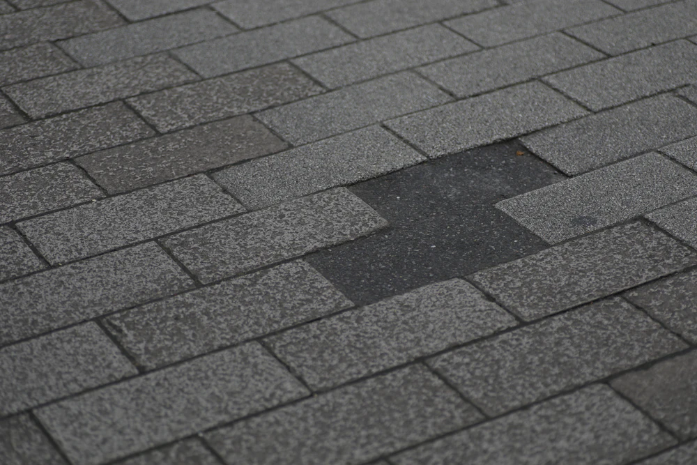 Asphalt shingle roof with missing shingles