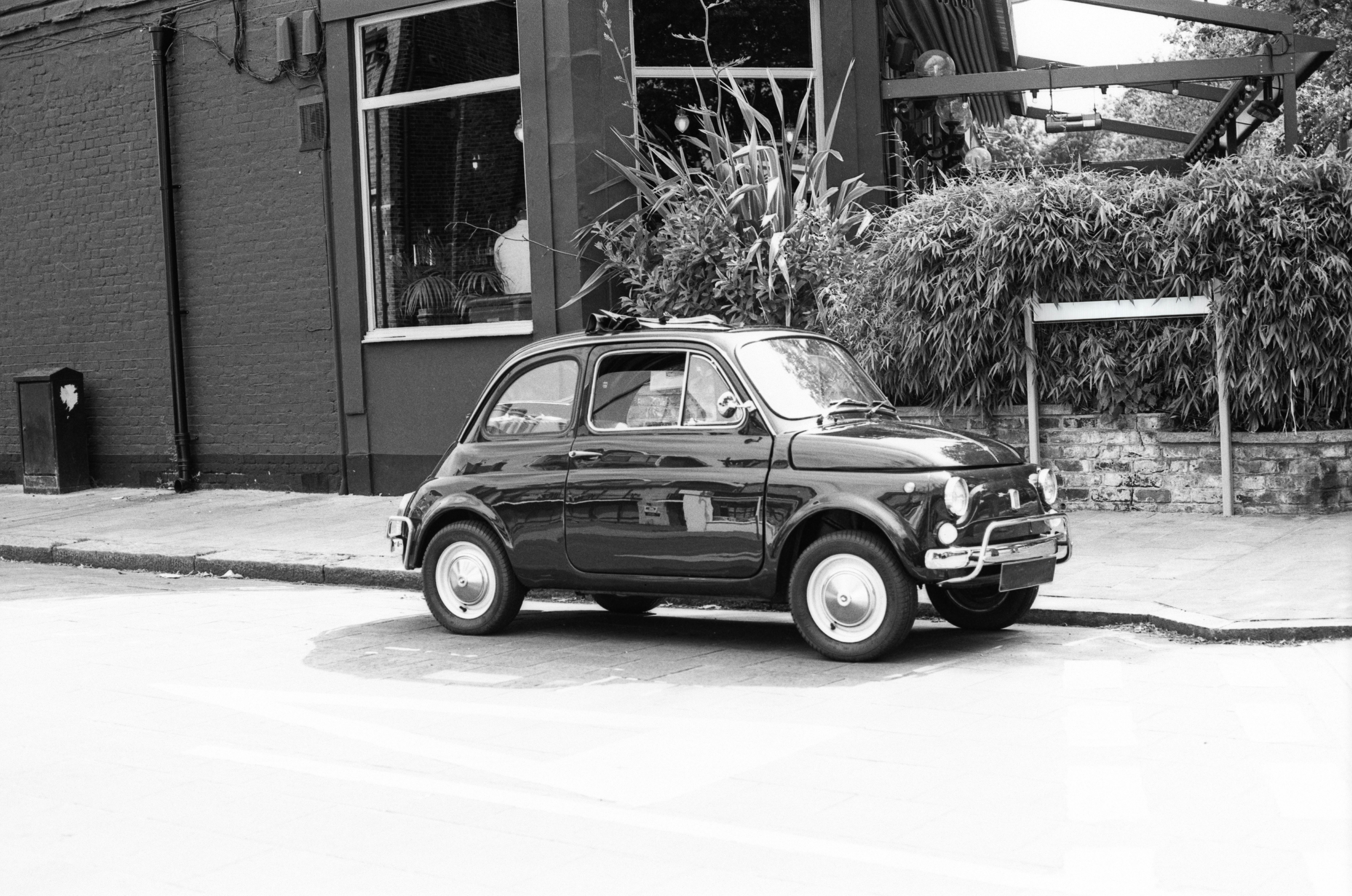 Vintage small car parked by building